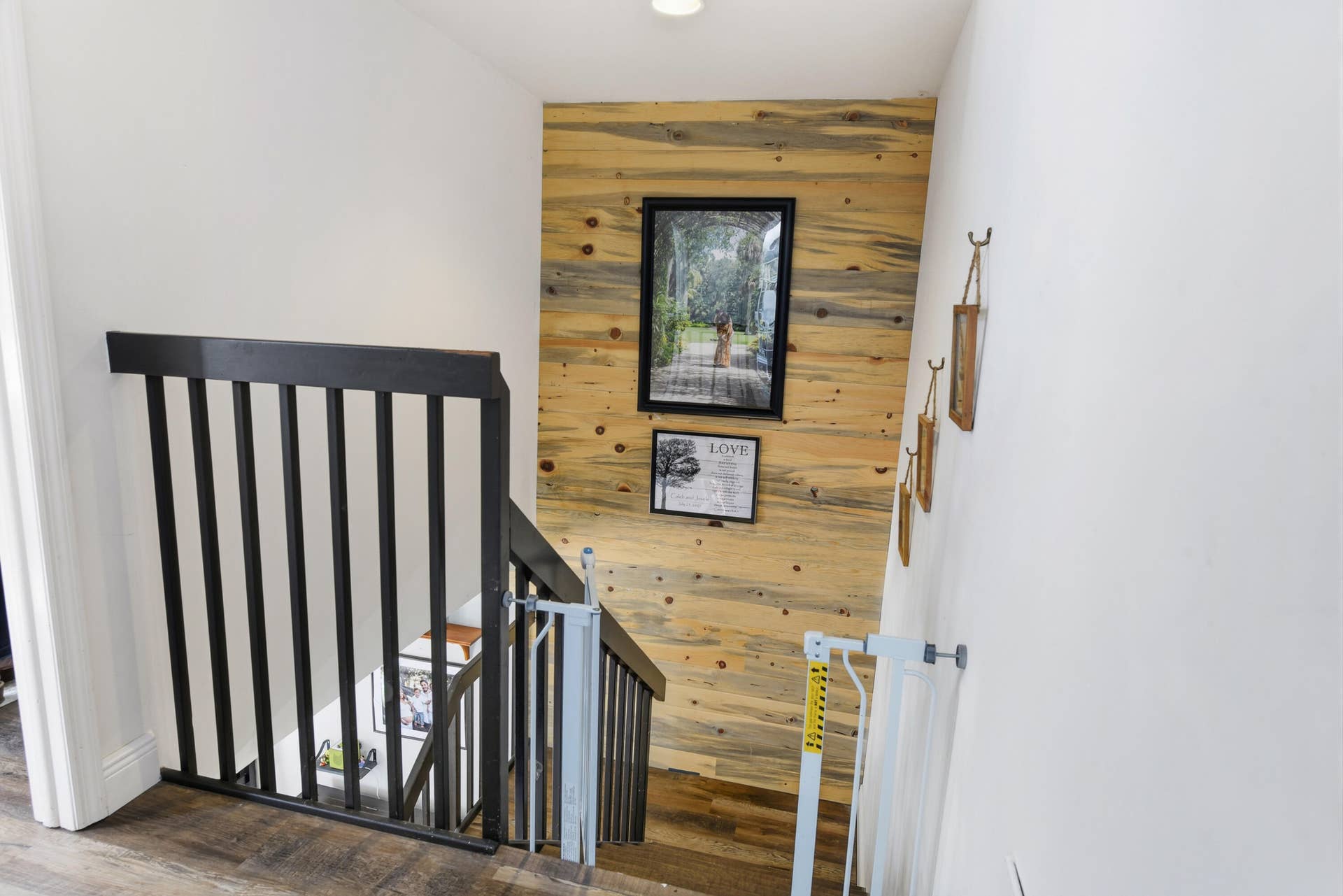 3233 SW SUNSET TRACE Circle, Palm City, FL 34990 Staircase featuring horizontal wood-plank accent wall and dark-finished wooden balusters