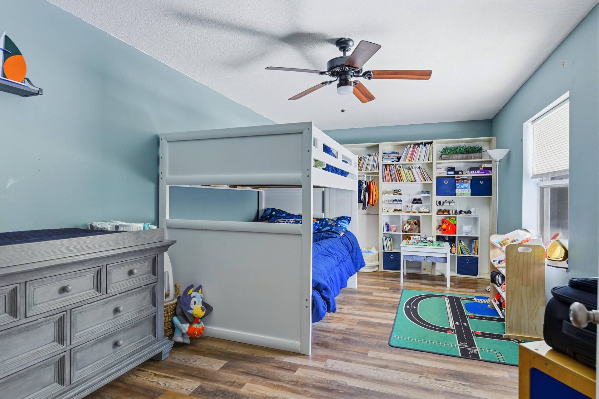 3233 SW SUNSET TRACE Circle, Palm City, FL 34990 Wood-finish flooring, ceiling fan with integrated lighting, and custom built-in floor-to-ceiling shelving unit