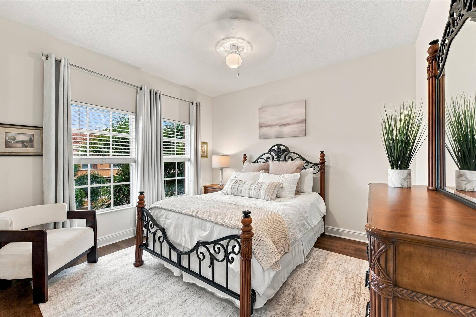 5545 NE Trieste Way, Boca Raton, FL 33487 Wood-finish flooring, dual windows with grid detailing, and central overhead lighting fixture