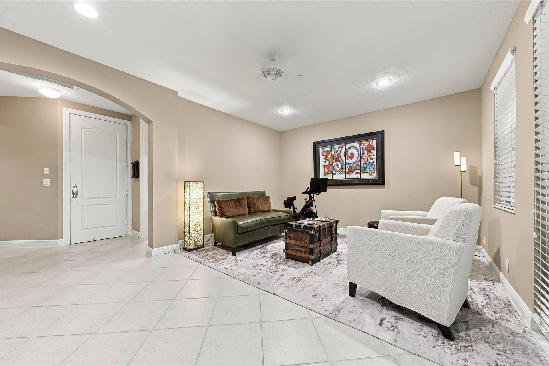 5545 NE Trieste Way, Boca Raton, FL 33487 Interior space featuring ceramic tile flooring, arched wall detailing, recessed lighting, and windows with horizontal blinds