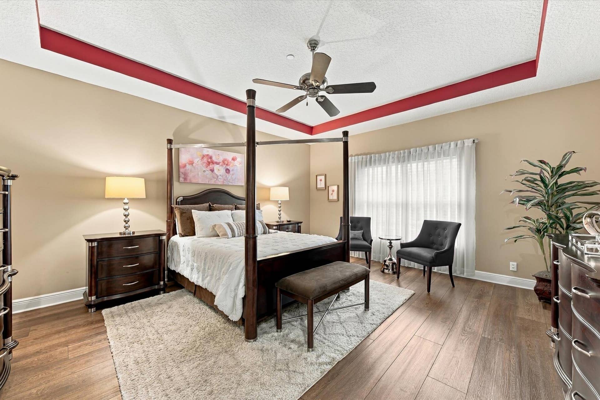 5545 NE Trieste Way, Boca Raton, FL 33487 Tray ceiling with decorative inset molding, wood-finish flooring, and a multi-speed ceiling fan
