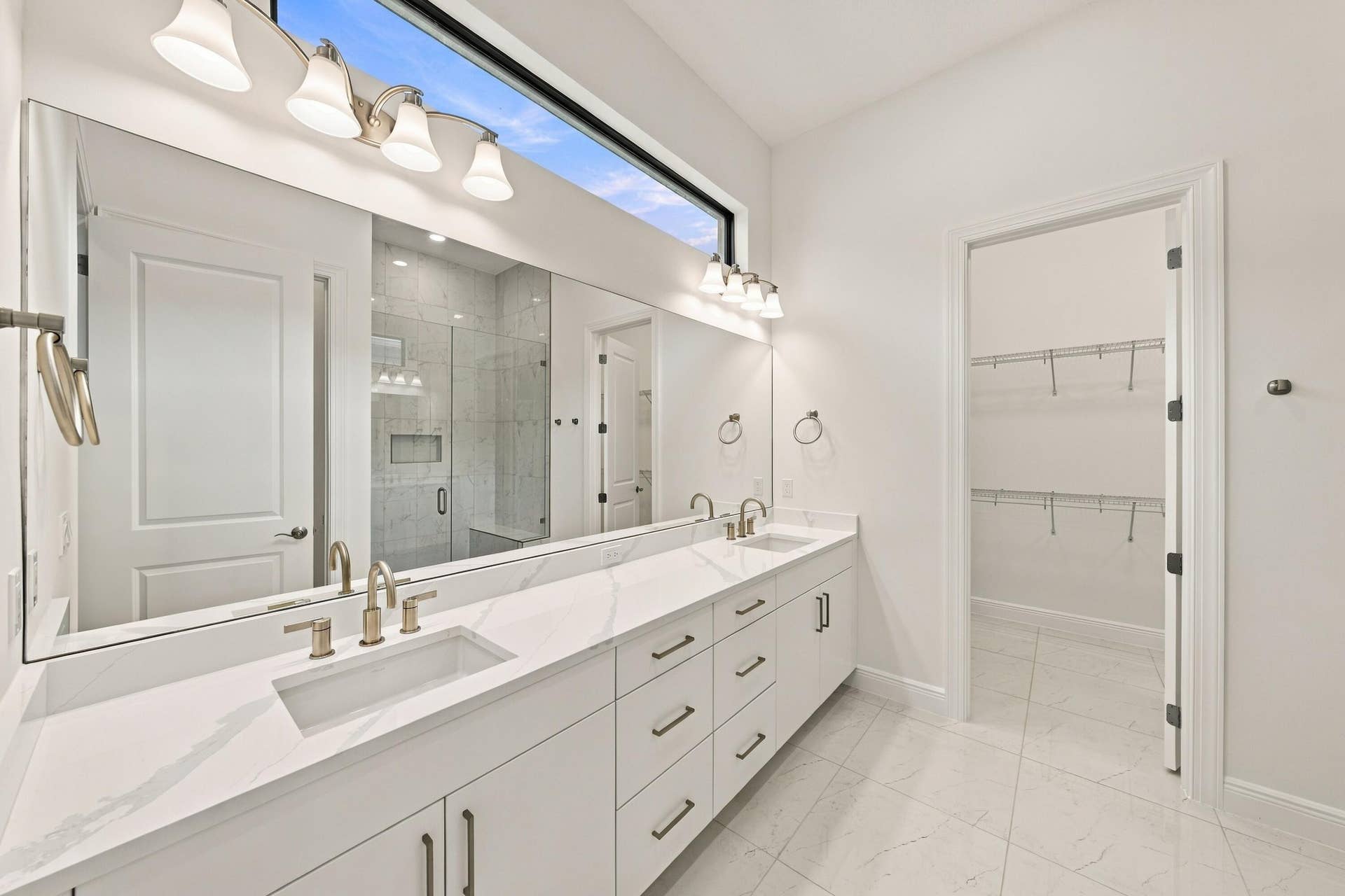 4931 Rivo Alto Circle, Westlake, FL 33470 Primary bathroom with quartz countertops, double sinks with soft close drawers and cabinets and walk-in closet