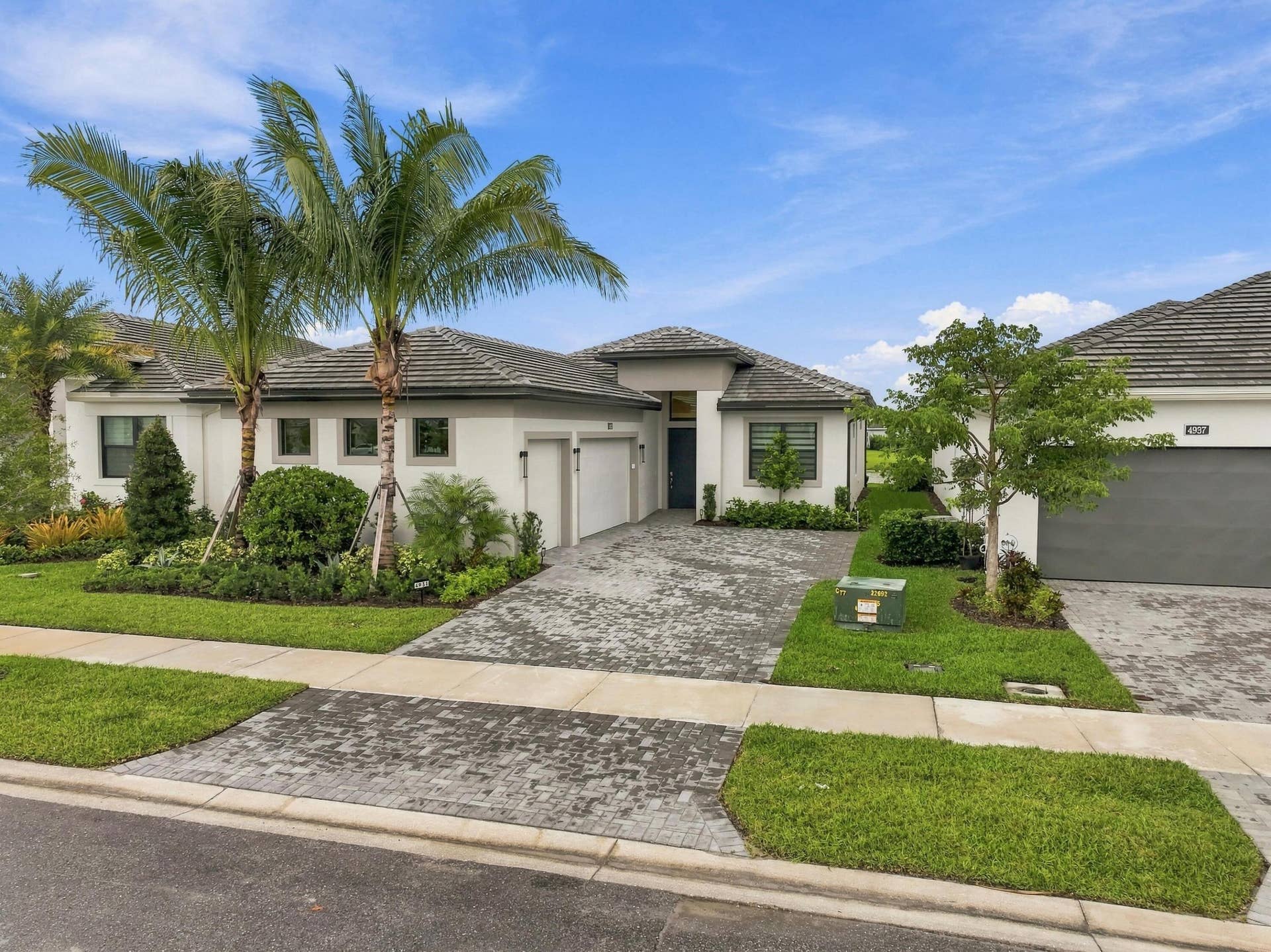 4931 Rivo Alto Circle, Westlake, FL 33470 Lila model with lush landscaping and paved driveway