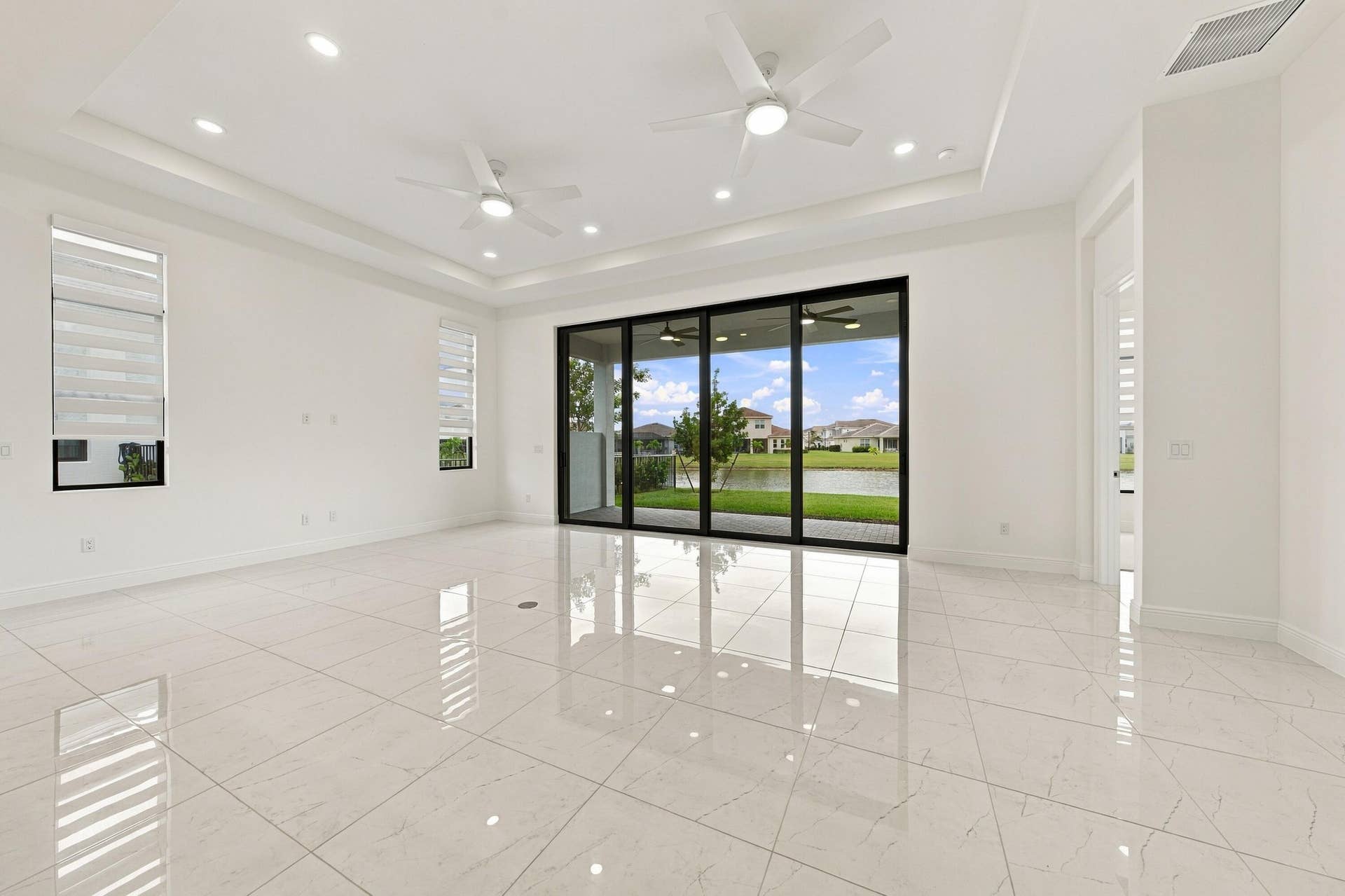 4931 Rivo Alto Circle, Westlake, FL 33470 Great room and dining area, tray ceiling, ceiling fans, zebra blinds and 10ft sliders