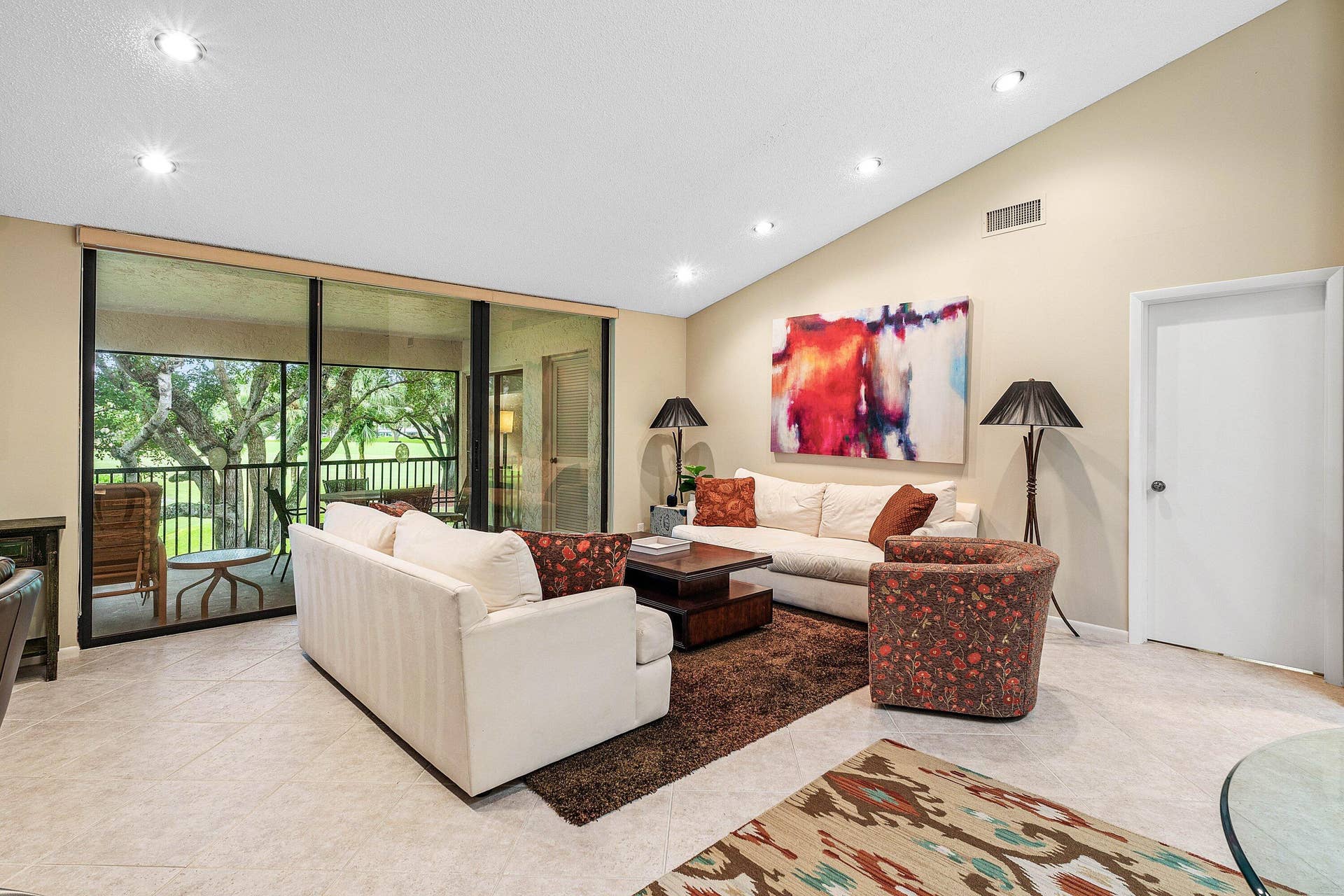 53 EASTGATE Drive, #B, Boynton Beach, FL 33436 Vaulted ceilings, large sliding glass doors, recessed lighting, and tile flooring