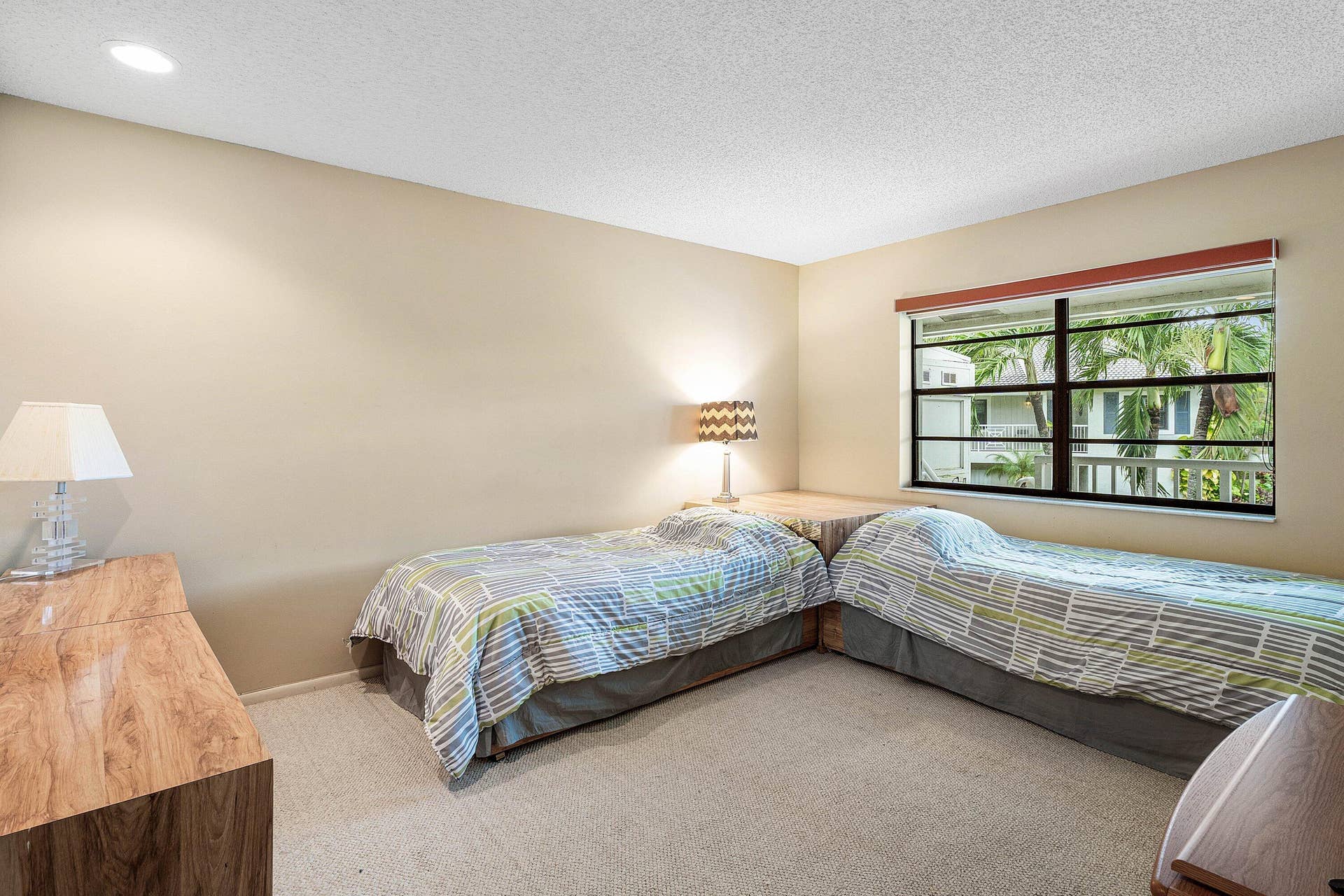 53 EASTGATE Drive, #B, Boynton Beach, FL 33436 Neutral-toned interior room featuring wall-to-wall carpeting, a multi-pane window with black framing, and recessed ceiling lighting