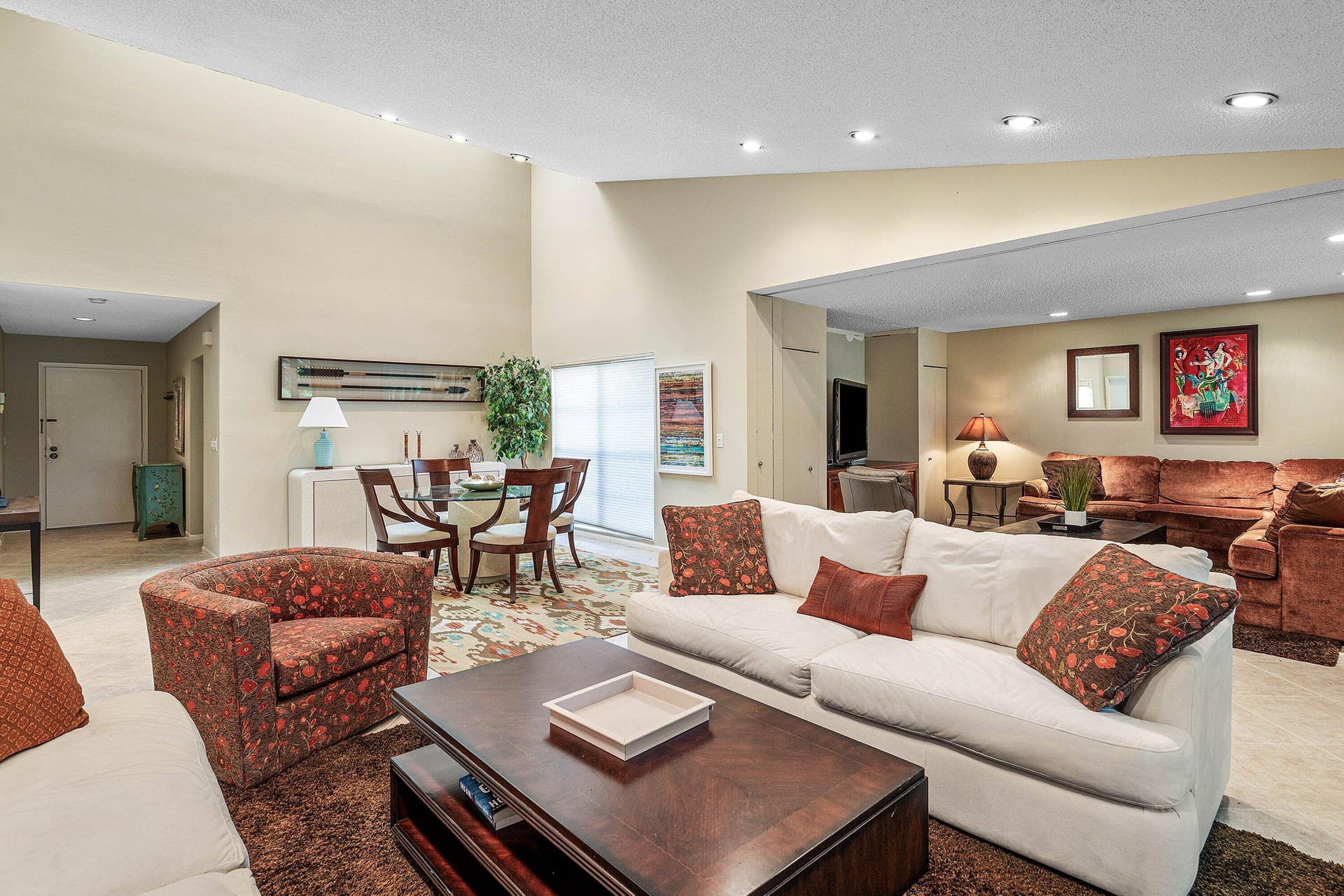 53 EASTGATE Drive, #B, Boynton Beach, FL 33436 Expansive living area featuring soaring vaulted ceilings, recessed lighting, and tile flooring