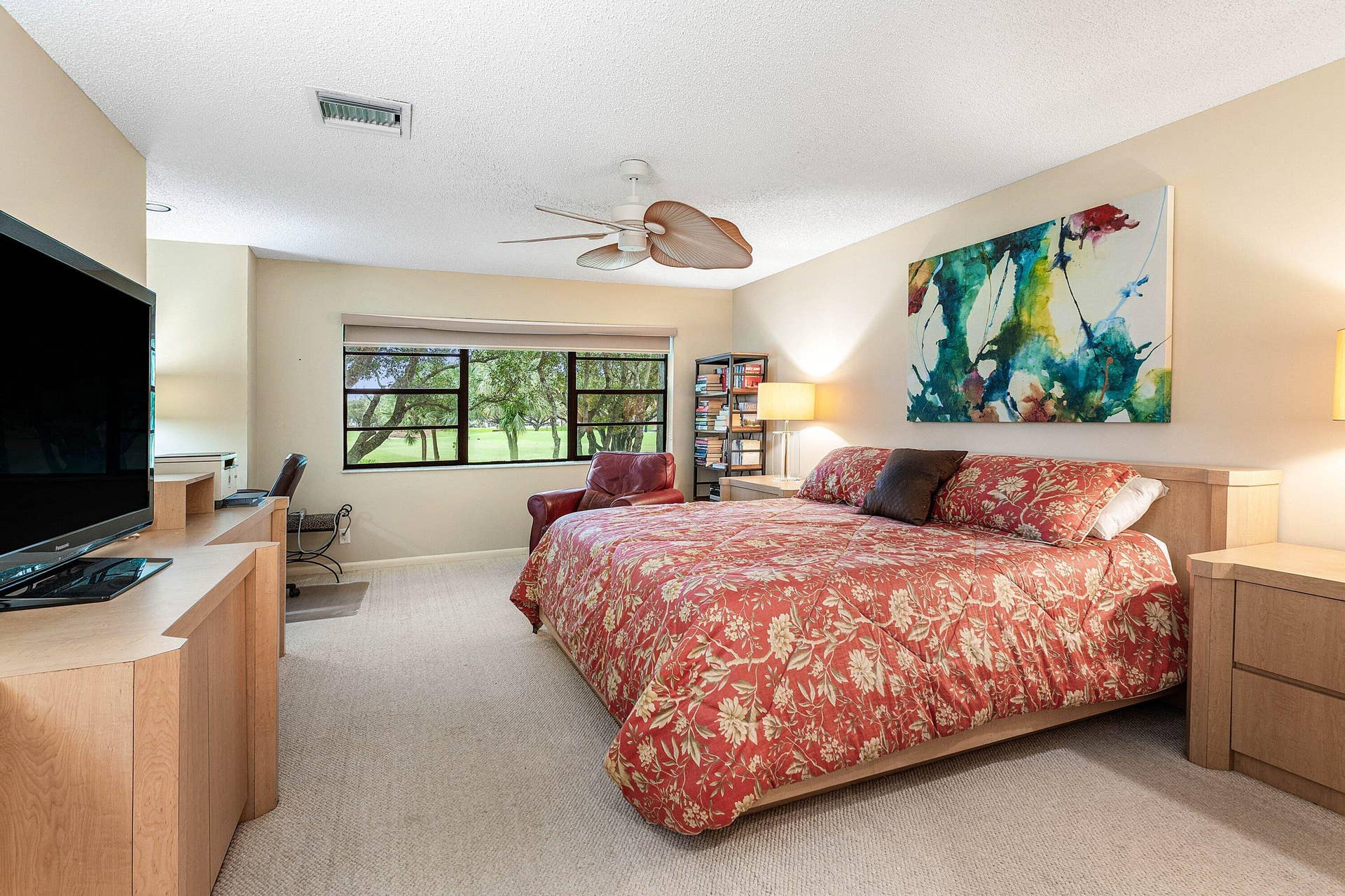 53 EASTGATE Drive, #B, Boynton Beach, FL 33436 Neutral-toned carpeting, ceiling-mounted paddle fan, built-in cabinetry, and multi-pane windows
