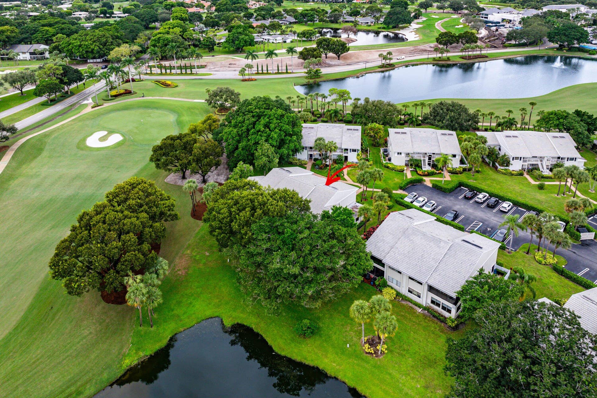 53 EASTGATE Drive, #B, Boynton Beach, FL 33436 Aerial perspective featuring multi-story residential architecture, shingled roofing, mature landscaping, and proximity to water and golf course terrain