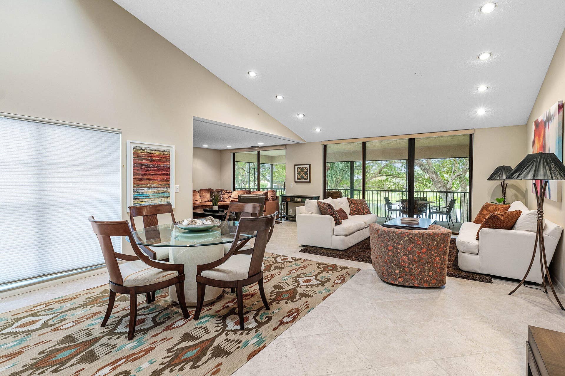 53 EASTGATE Drive, #B, Boynton Beach, FL 33436 Vaulted ceilings featuring recessed lighting, large-format tile flooring, and floor-to-ceiling sliding glass doors