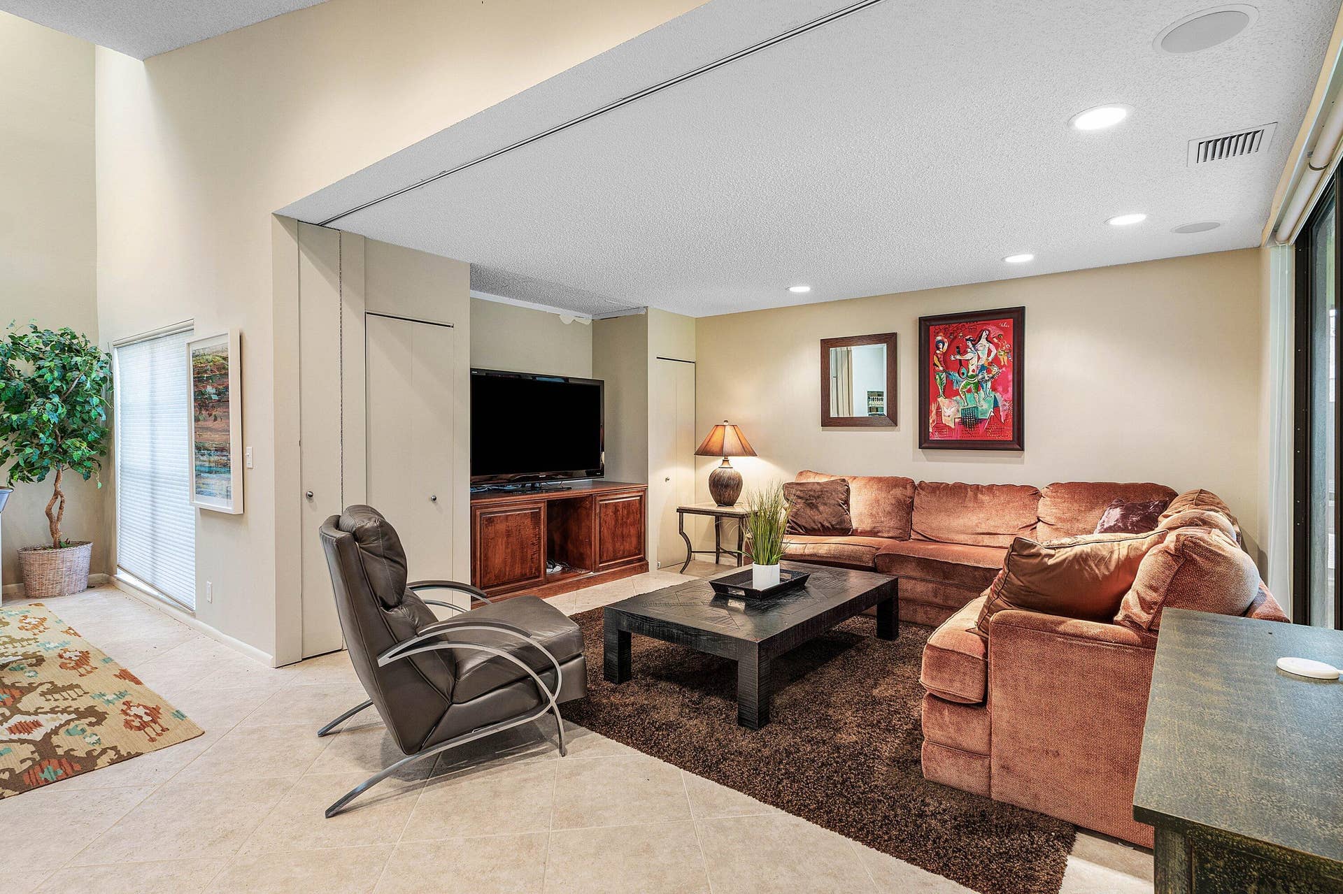 53 EASTGATE Drive, #B, Boynton Beach, FL 33436 Living space featuring vaulted ceilings, recessed lighting, tile flooring, and built-in cabinetry