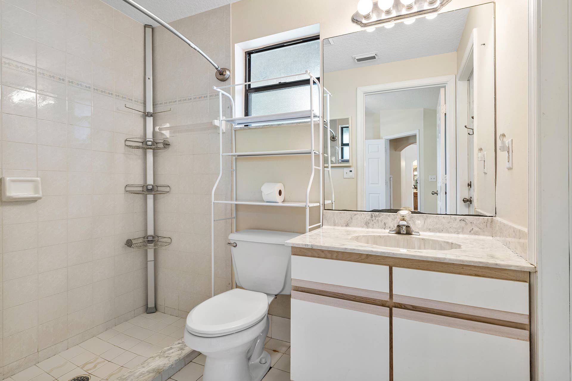 13677 Citrus Grove Boulevard, West Palm Beach, FL 33412 Primary bathroom ensuite number two featuring a vanity with a stone-top counter, undermount sink, and full-width vanity mirror