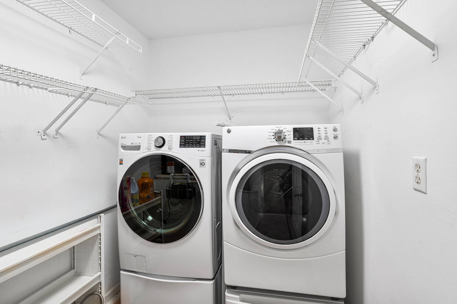 13677 Citrus Grove Boulevard, West Palm Beach, FL 33412 Laundry room featuring new white appliances, integrated pedestals, and multi-level wire shelving