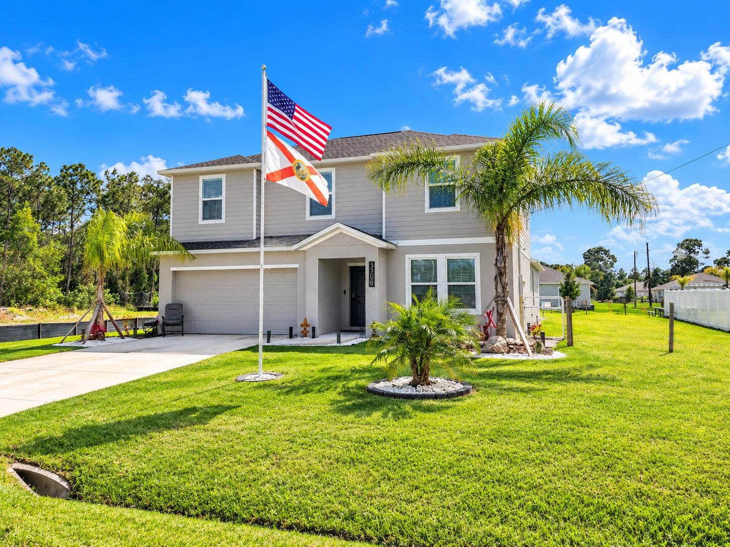 Sunny Suburban Home with Florida Flags