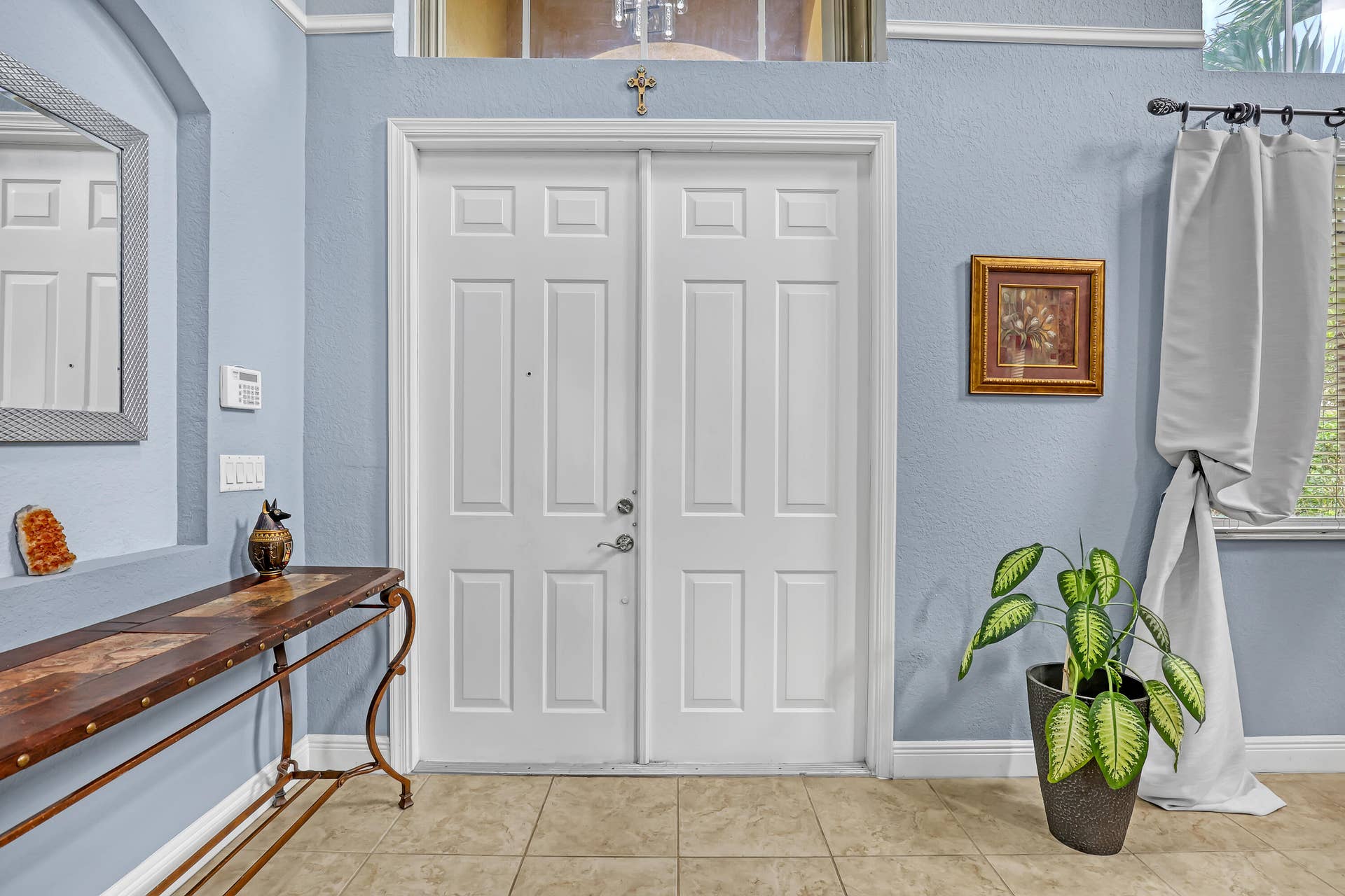 762 GAZETTA Way, West Palm Beach, FL 33413 Double-door entry featuring paneled construction, high ceilings with a transom window, recessed wall niche, and tile flooring