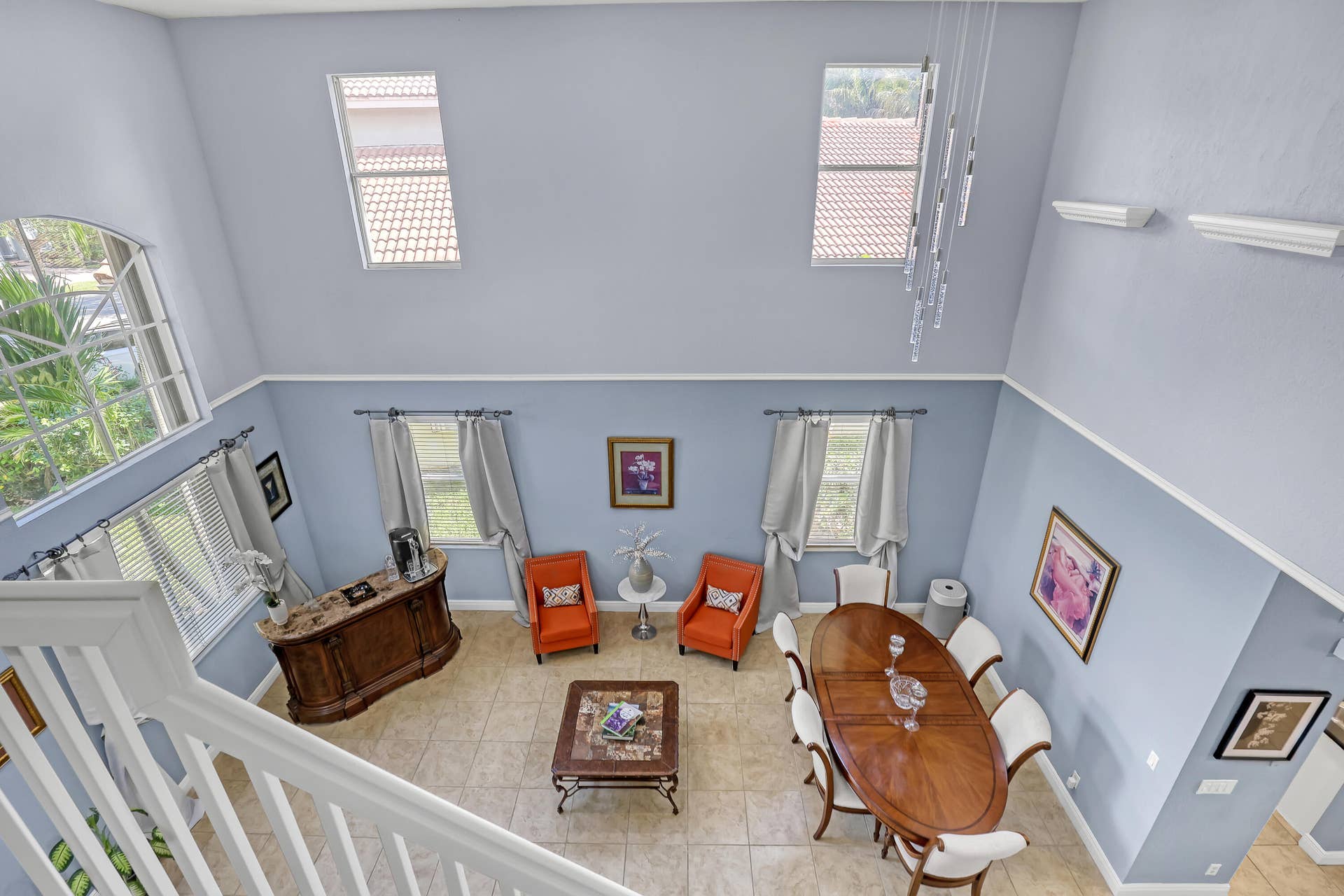 762 GAZETTA Way, West Palm Beach, FL 33413 Double-height ceilings featuring multi-tiered windows, tile flooring, and a contemporary multi-pendant light fixture