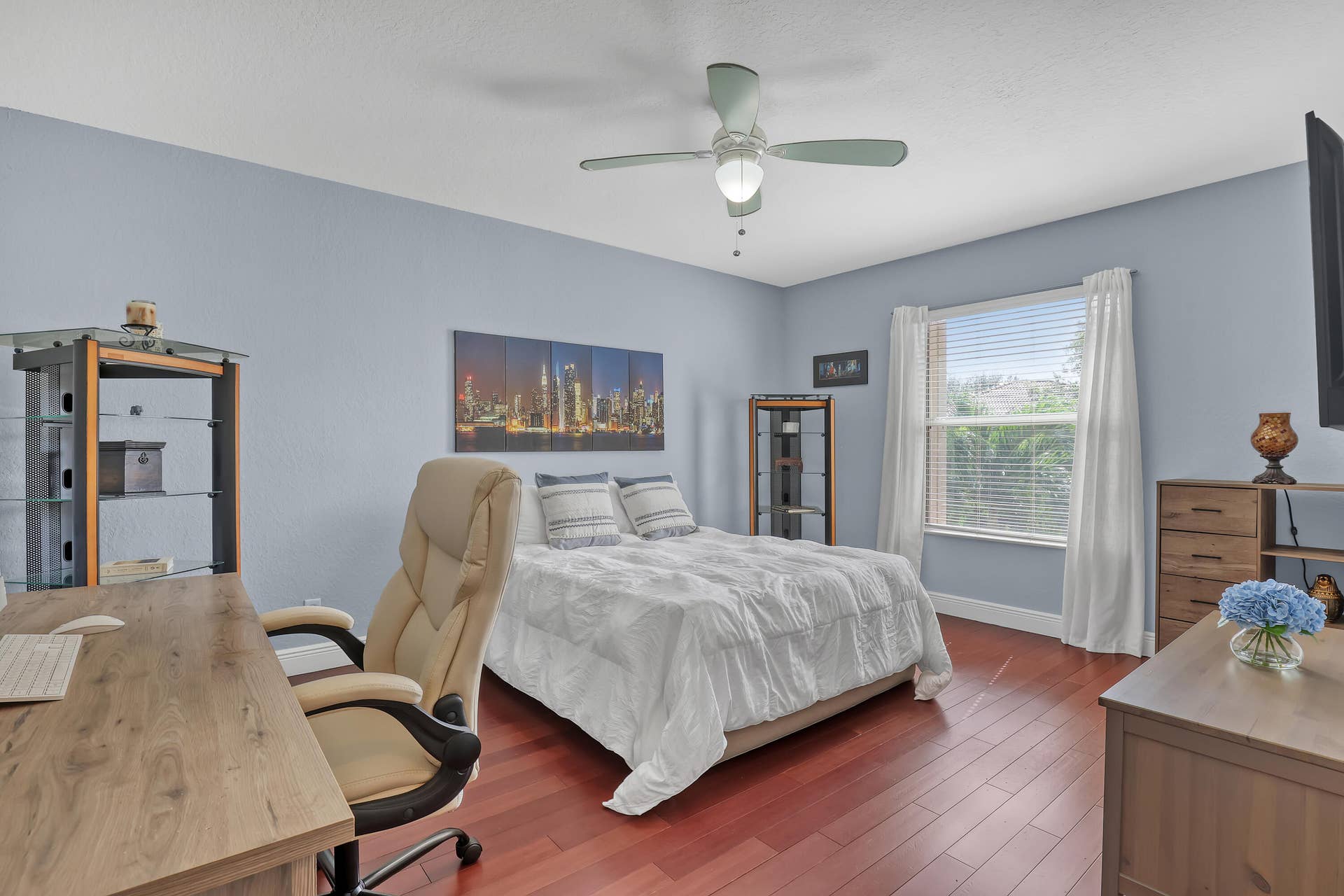 762 GAZETTA Way, West Palm Beach, FL 33413 Room featuring wood-finish flooring, a centrally mounted ceiling fan with integrated lighting, and a window with horizontal blinds