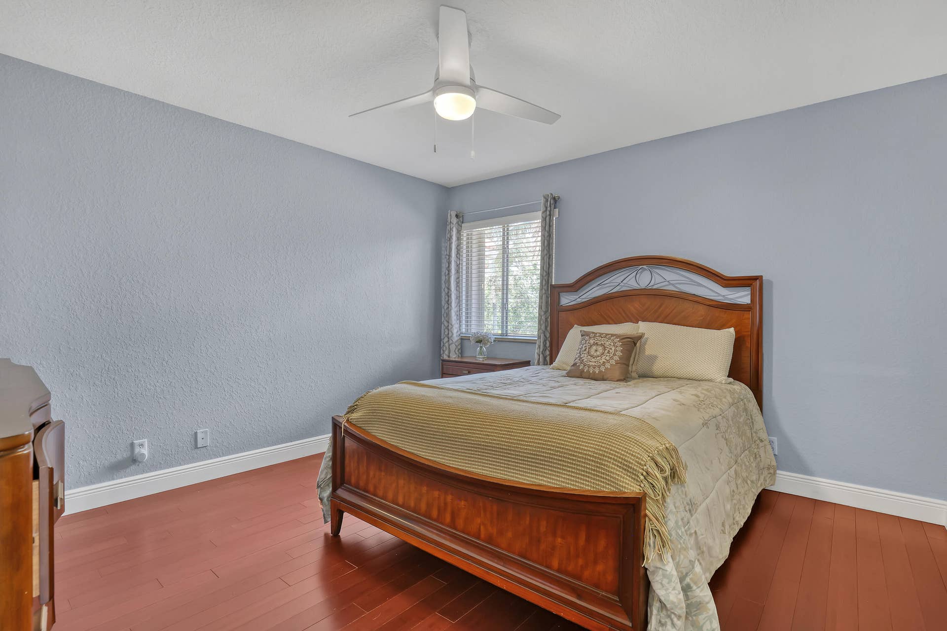 762 GAZETTA Way, West Palm Beach, FL 33413 Room featuring wood-finish flooring, a white three-blade ceiling fan with integrated lighting, and a single-pane window