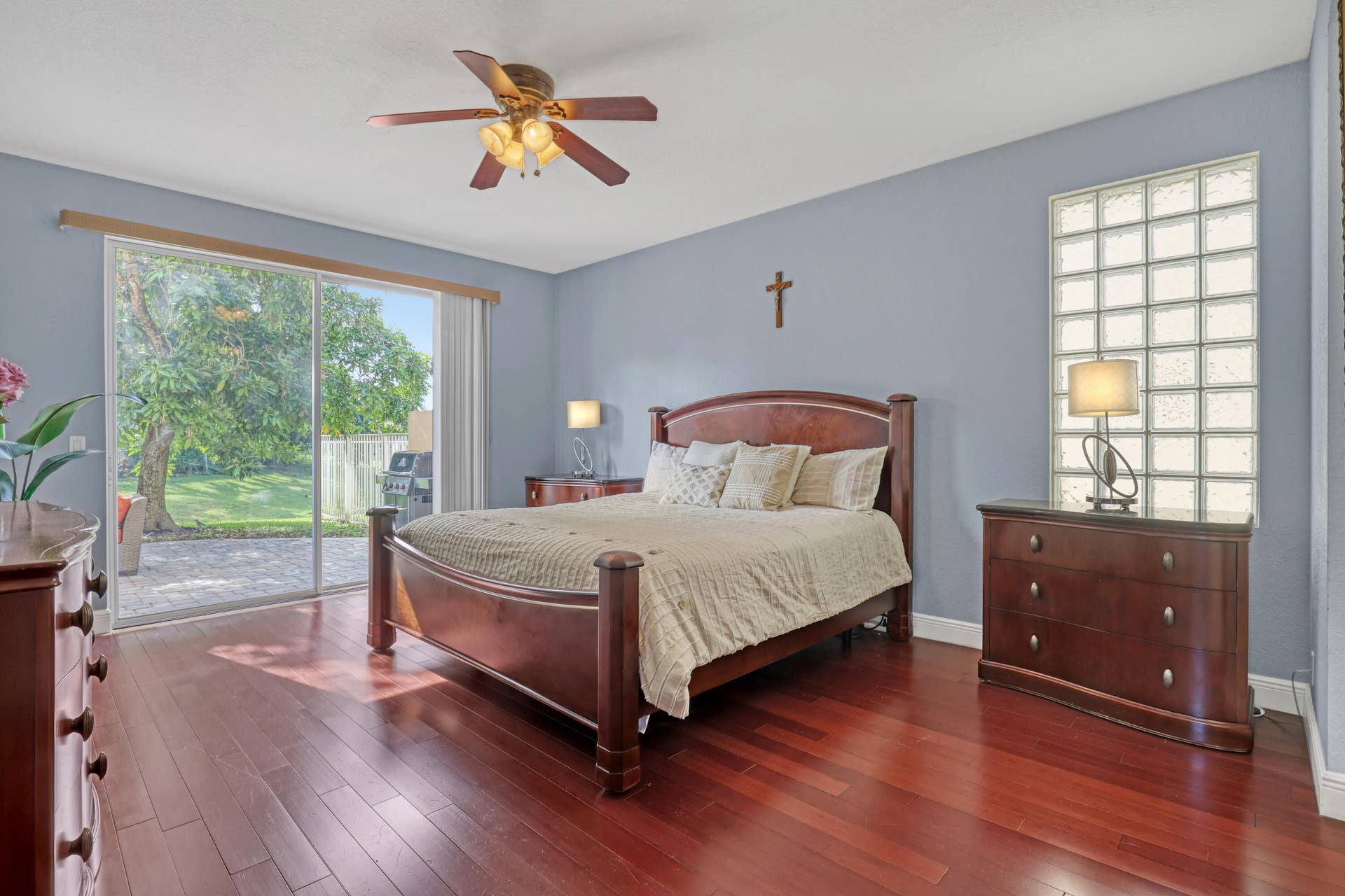 762 GAZETTA Way, West Palm Beach, FL 33413 Wood-finish flooring, glass block window, sliding glass door, and ceiling fan with integrated lighting