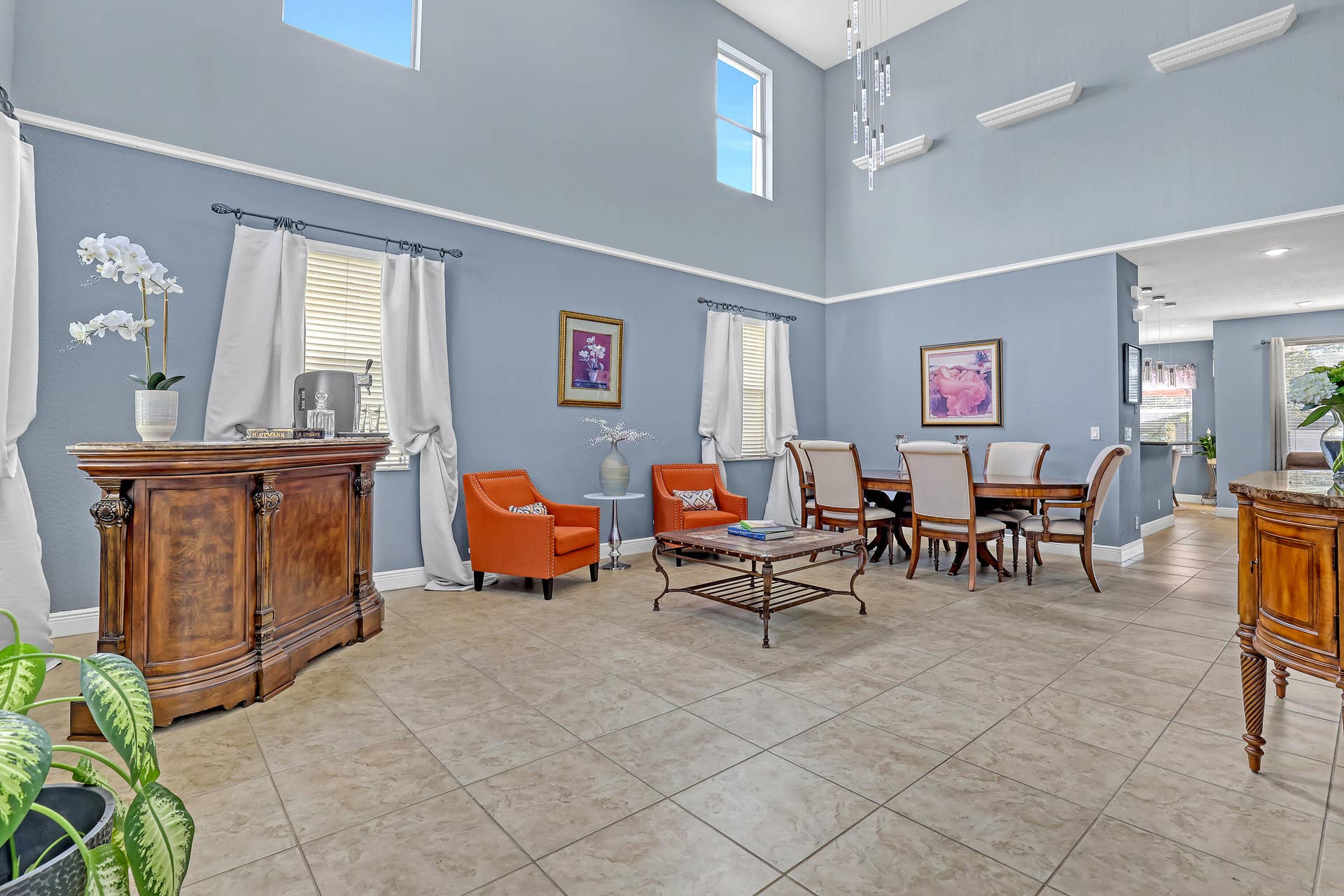 762 GAZETTA Way, West Palm Beach, FL 33413 Double-height ceilings featuring transom windows, tile flooring, and a multi-light pendant chandelier