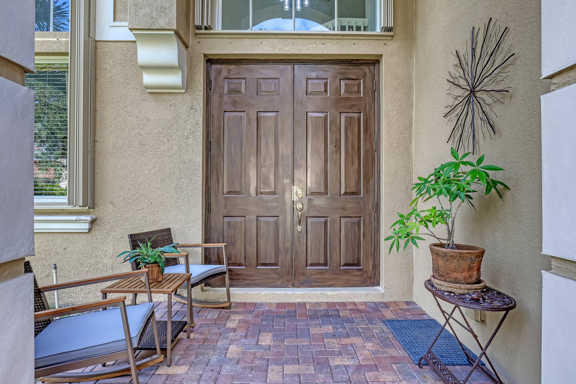 762 GAZETTA Way, West Palm Beach, FL 33413 Double entry doors with a rich wood finish, multi-pane transom window, and paver stone porch