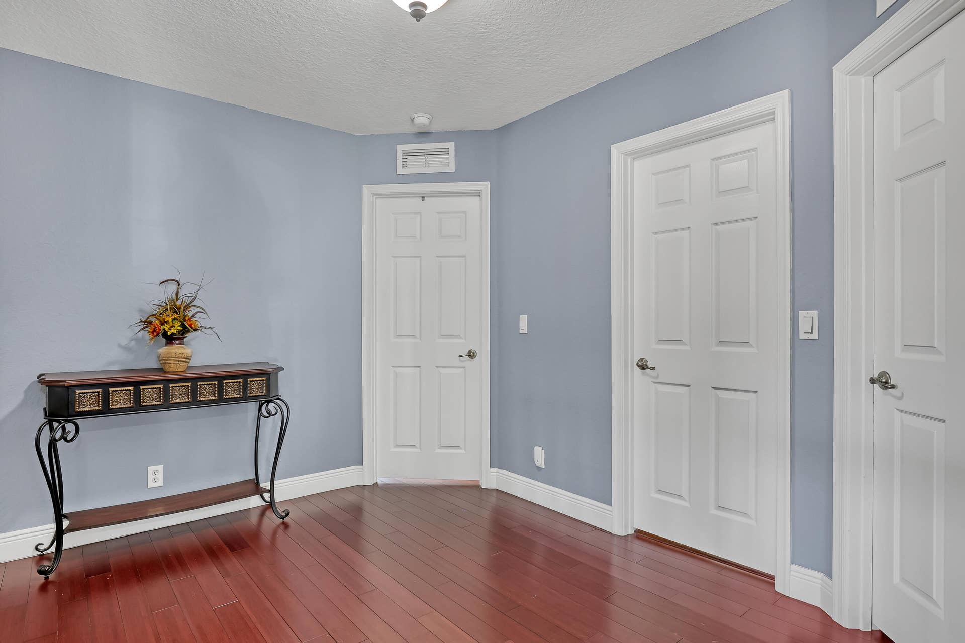 762 GAZETTA Way, West Palm Beach, FL 33413 Wood-finish flooring, six-panel interior doors, and a ceiling-mounted light fixture