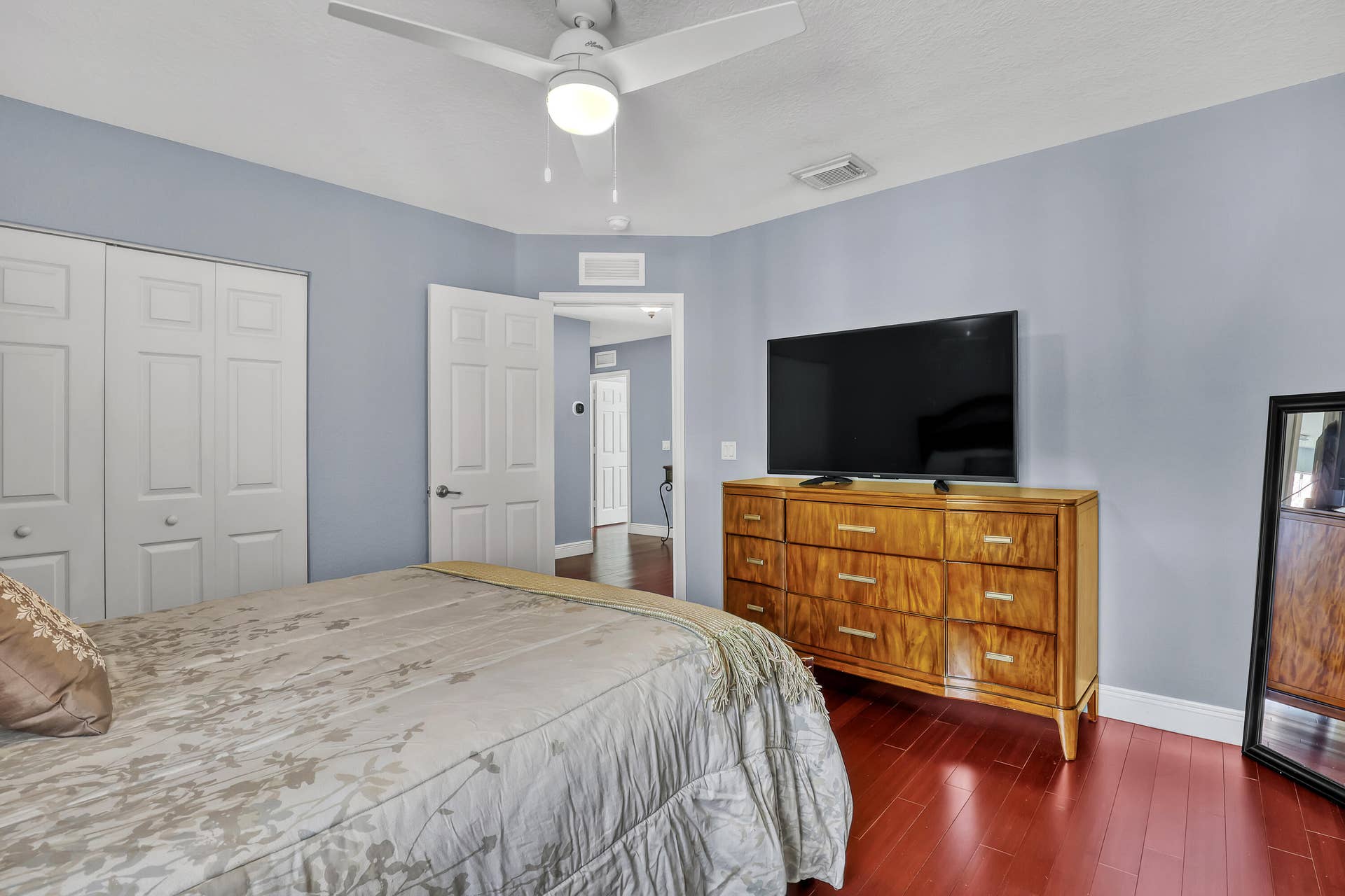 762 GAZETTA Way, West Palm Beach, FL 33413 Room featuring wood-finish flooring, a ceiling fan with integrated lighting, and a dual-panel closet