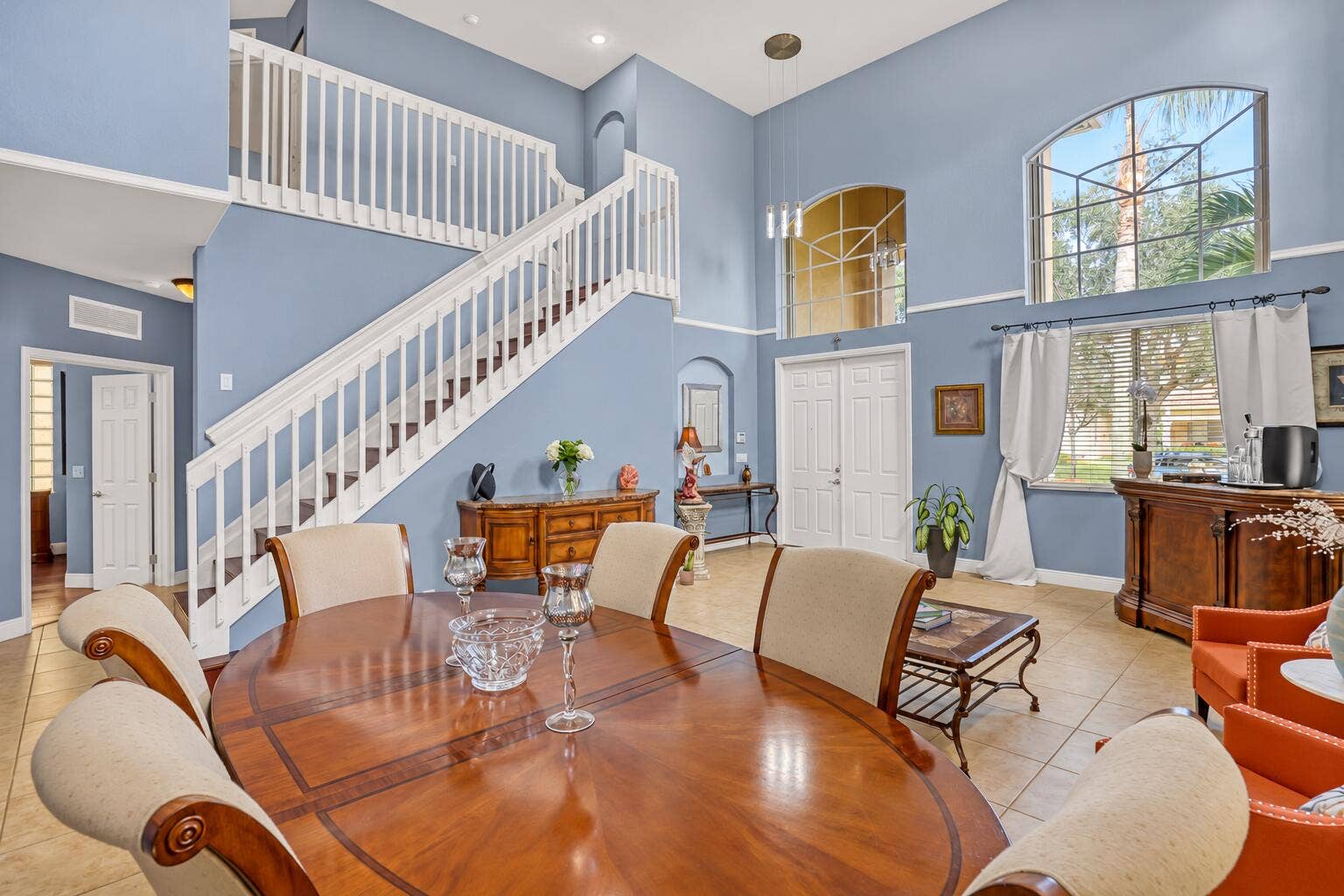 762 GAZETTA Way, West Palm Beach, FL 33413 High-ceiling living area featuring tile flooring, expansive arched windows, crisp wall molding, and recessed lighting
