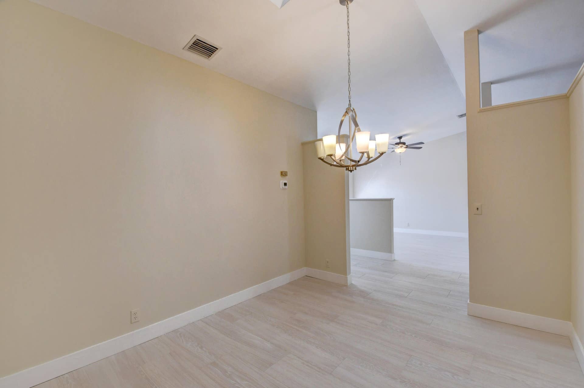 Elegant Dining Area with Chandelier & Vaulted Ceiling