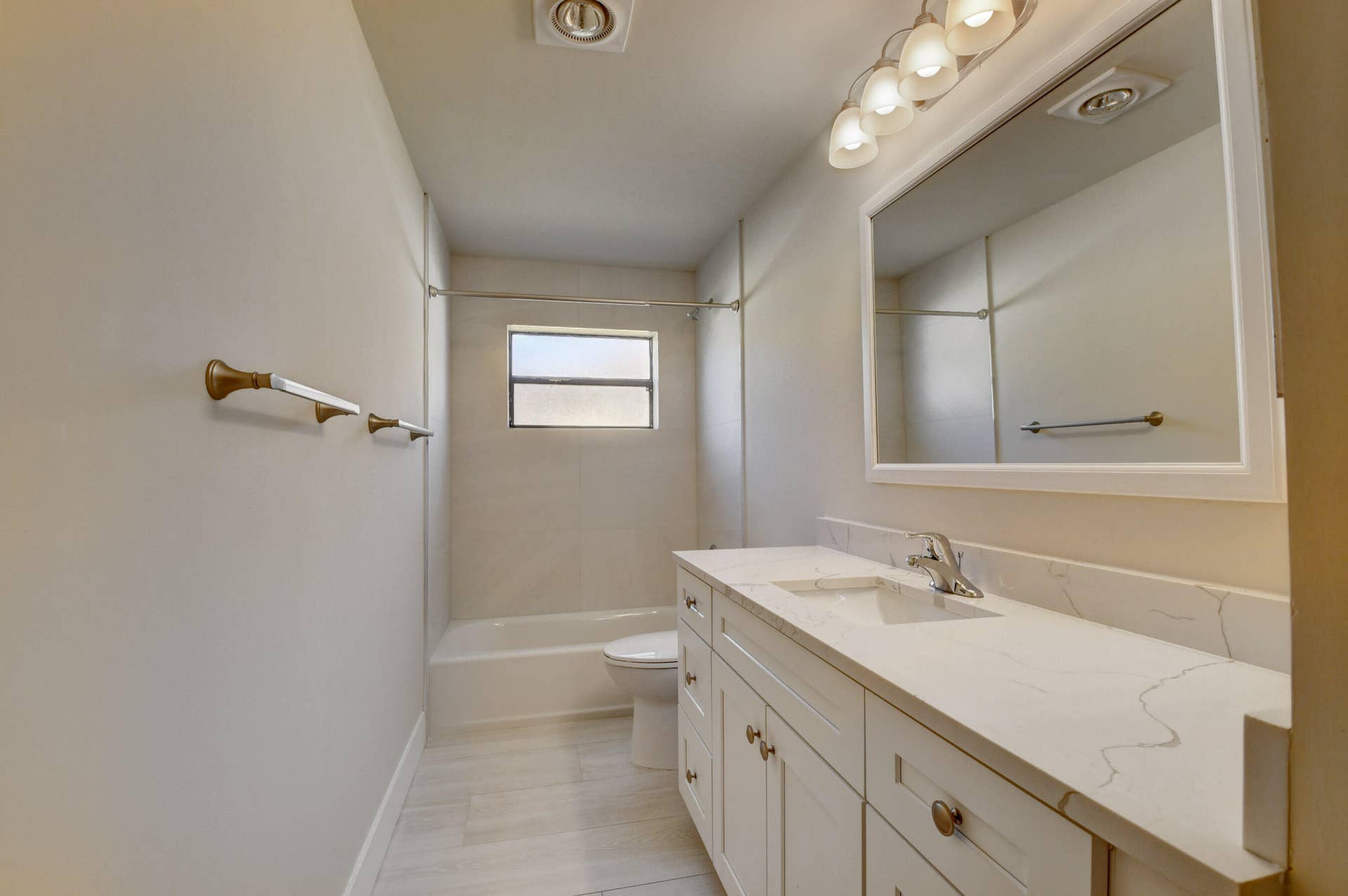 Bright Guest Bathroom with Extended Vanity, Modern Fixtures & Tub-Shower Combination