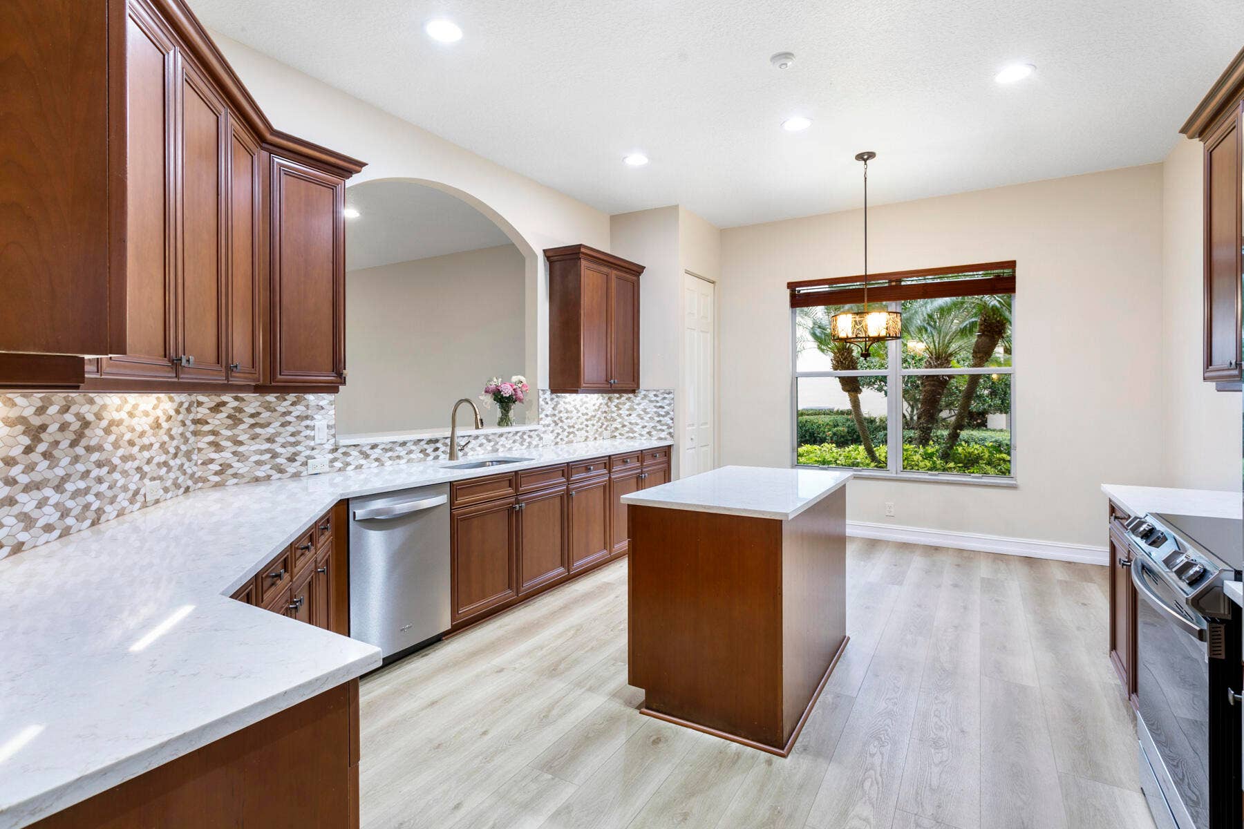 Kitchen was updated with new flooring, white quartz countertops and s/s appliances