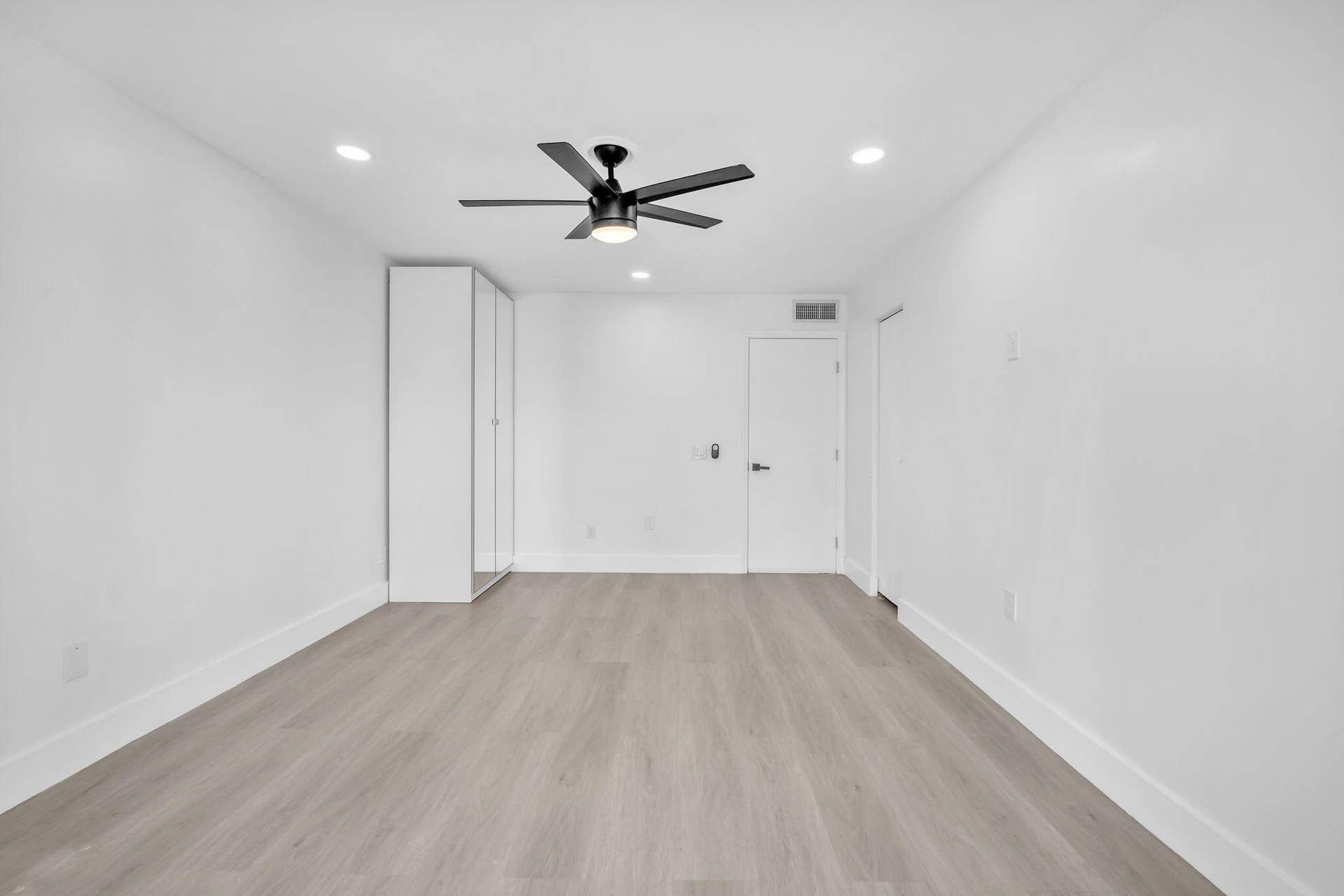 4162 SW 65th Avenue, #84, Davie, FL 33314 Interior room featuring light-toned wood-finish flooring, recessed lighting, a matte black ceiling fan with integrated light, and built-in floor-to-ceiling cabinetry