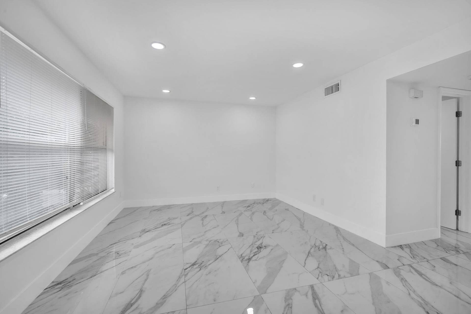 4162 SW 65th Avenue, #84, Davie, FL 33314 Large-format stone-look tile flooring, recessed ceiling lighting, and horizontal window blinds