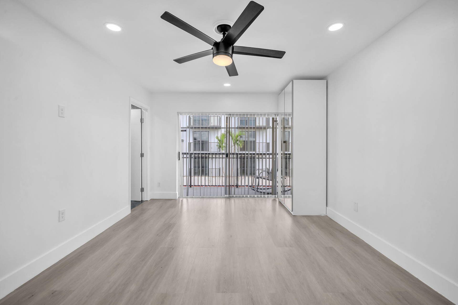 4162 SW 65th Avenue, #84, Davie, FL 33314 Wood-finish flooring, recessed lighting, ceiling fan with integrated light, built-in storage cabinetry, and sliding glass doors with exterior access