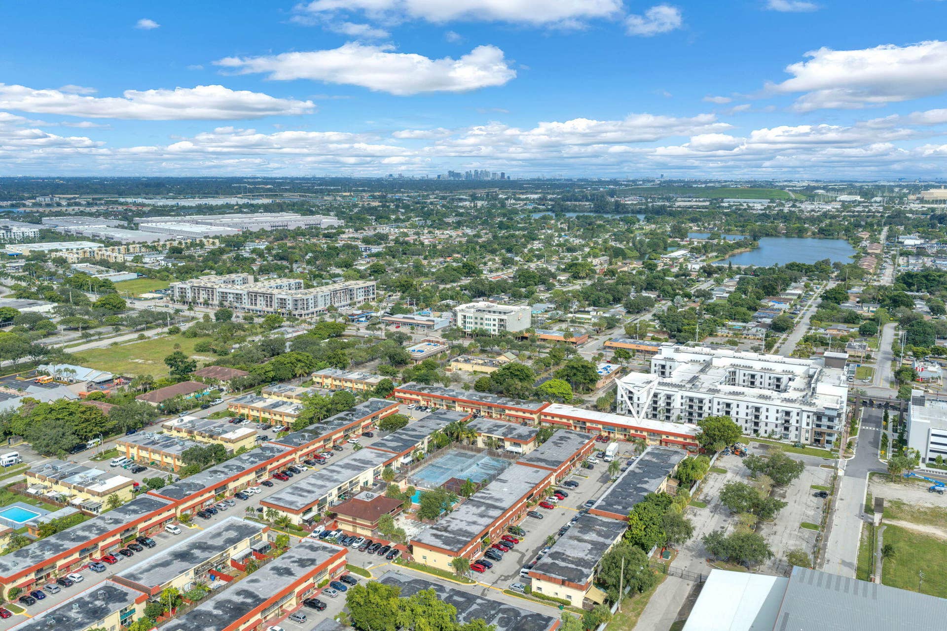 4162 SW 65th Avenue, #84, Davie, FL 33314 Aerial perspective of a multi-unit complex featuring an on-site swimming pool, designated parking areas, and mature landscaping