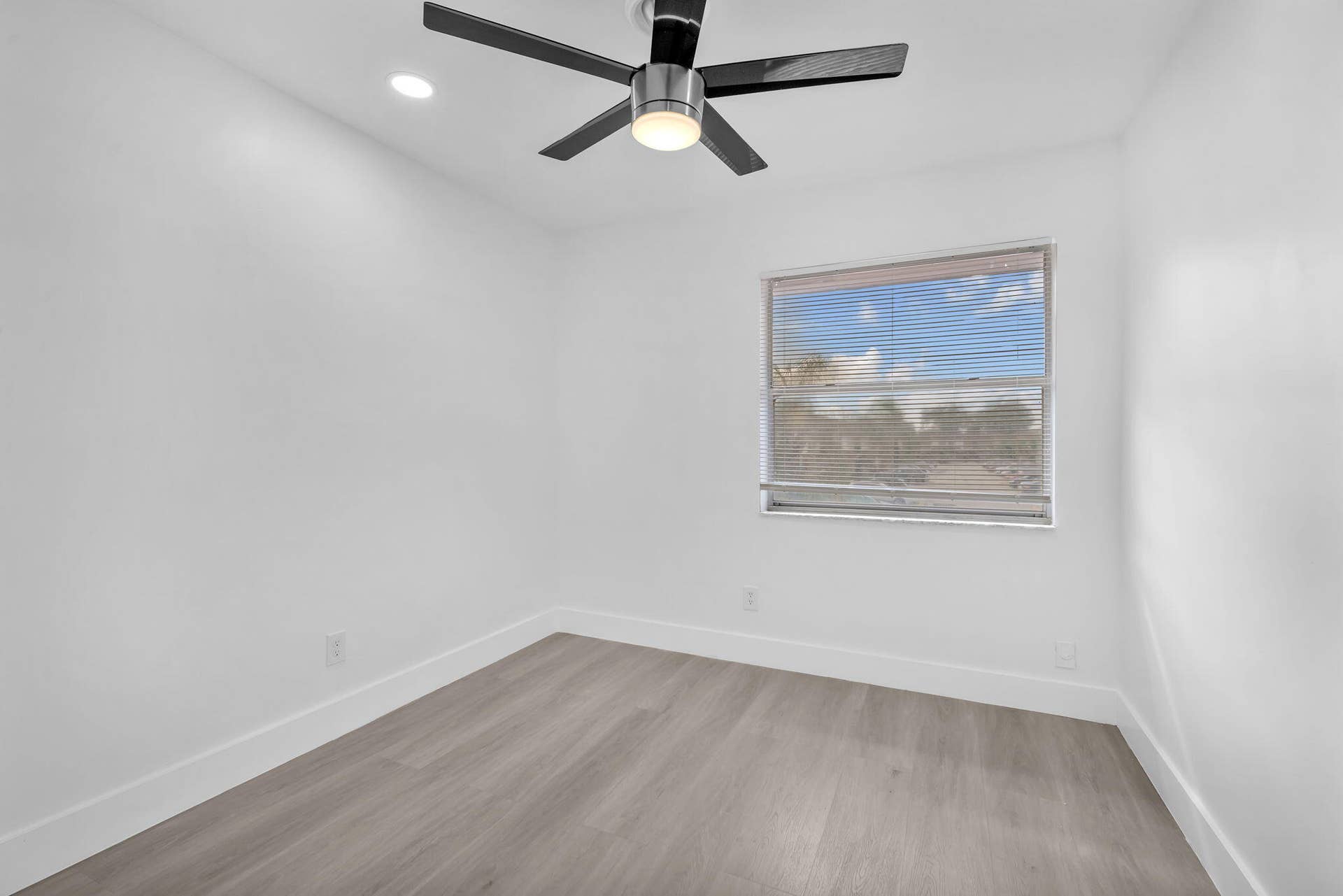 4162 SW 65th Avenue, #84, Davie, FL 33314 Room featuring wood-finish flooring, a contemporary ceiling fan with integrated lighting, recessed lighting, and a window with horizontal blinds