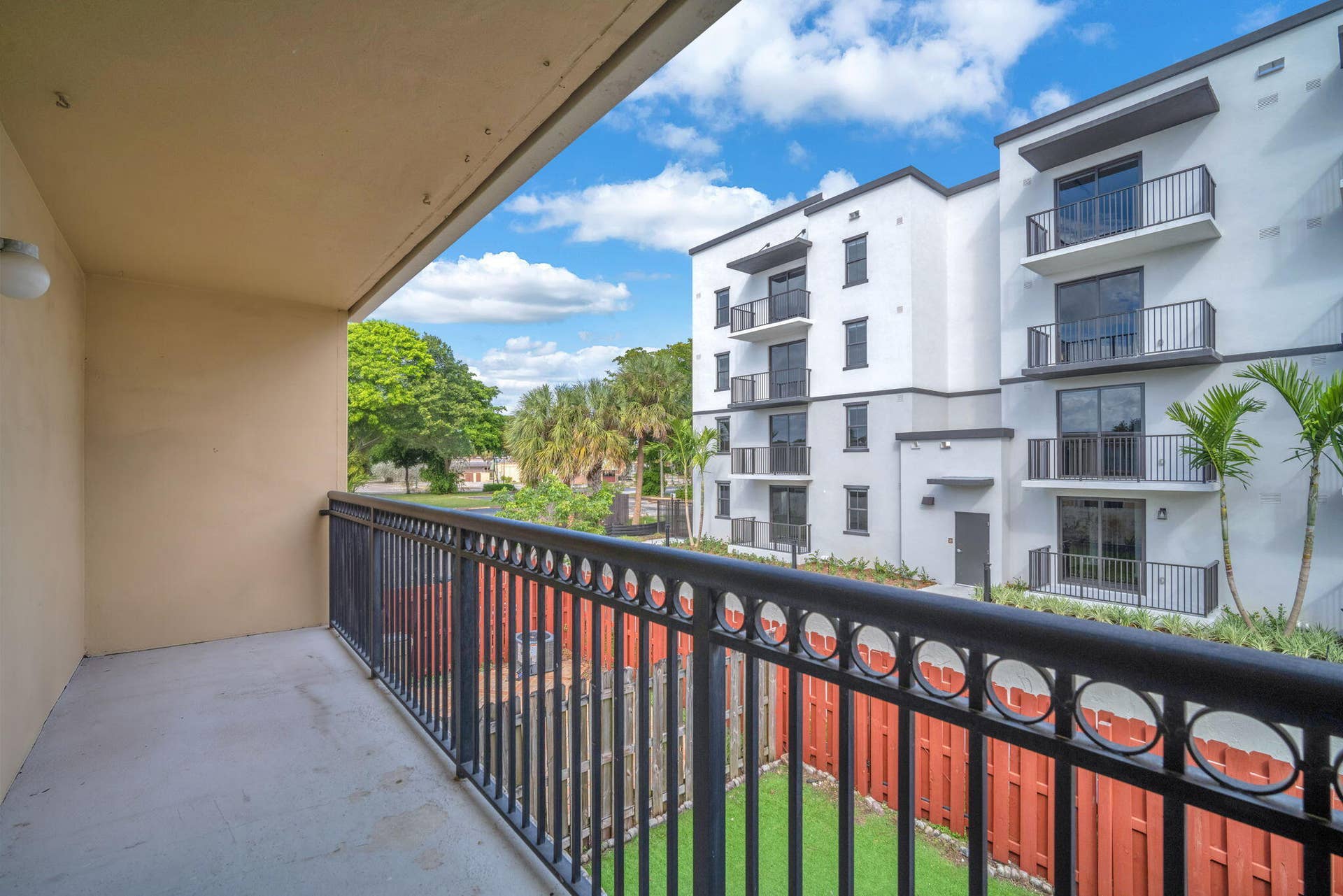4162 SW 65th Avenue, #84, Davie, FL 33314 Covered balcony featuring black metal railings and concrete flooring