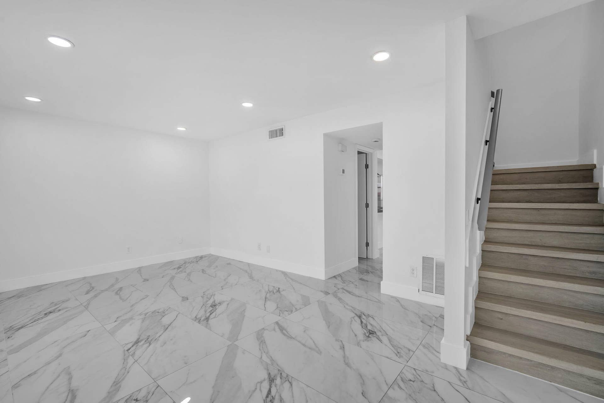 4162 SW 65th Avenue, #84, Davie, FL 33314 Large-format stone-style tile flooring, recessed ceiling lighting, and staircase featuring wood-finish treads and a metal handrail