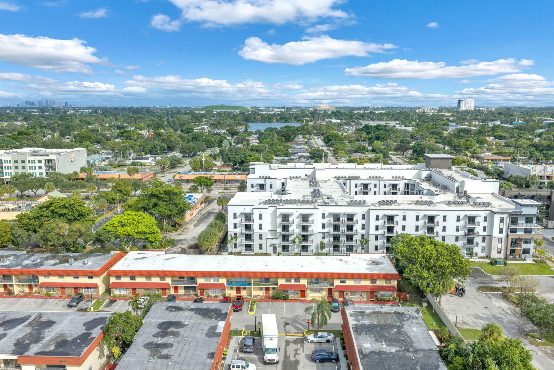4162 SW 65th Avenue, #84, Davie, FL 33314 Aerial perspective featuring multi-story residential buildings, paved surface parking lots, and established landscaping with mature trees