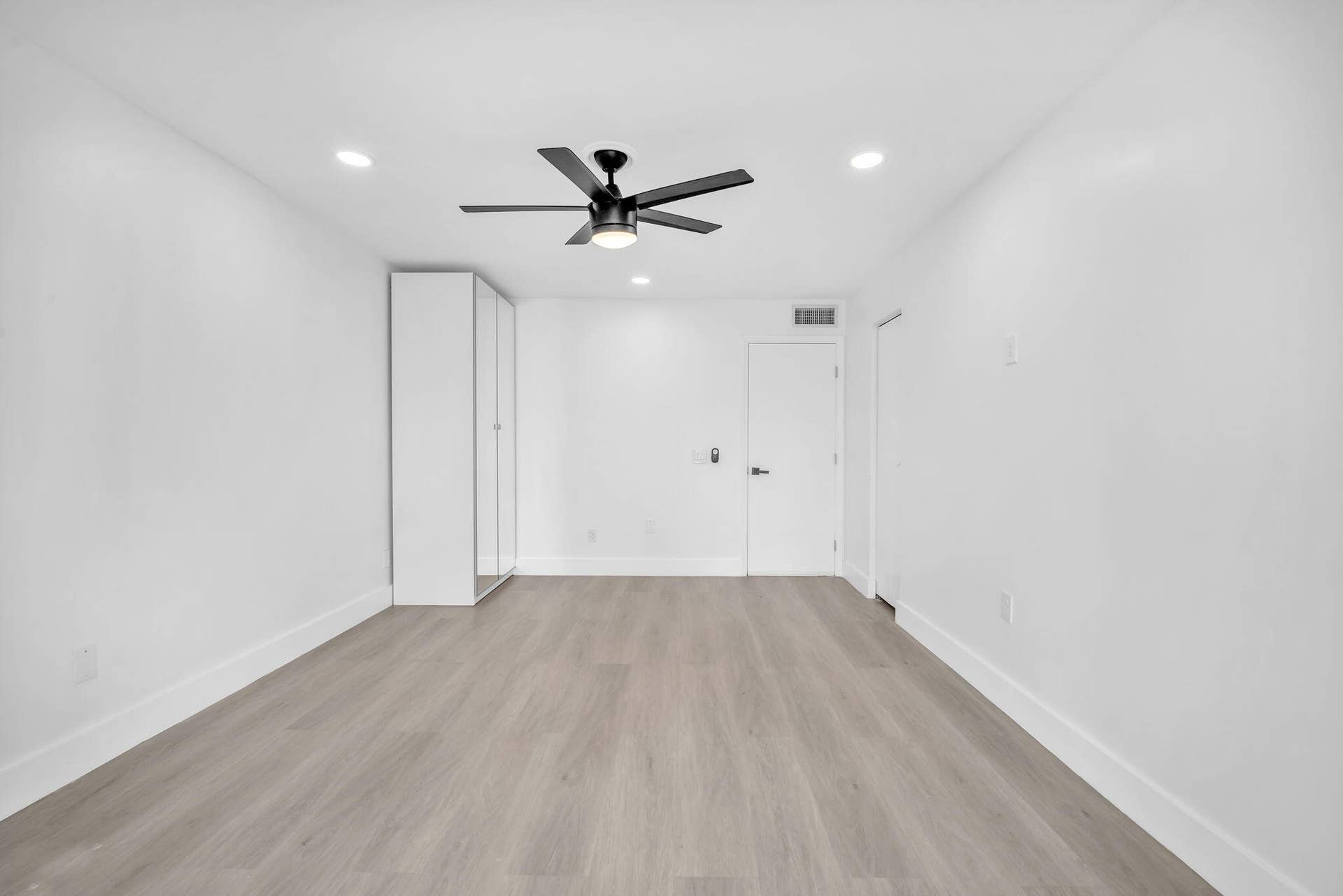 4162 SW 65th Avenue, #84, Davie, FL 33314 Neutral-toned wood-finish flooring, recessed lighting, matte black ceiling fan, and floor-to-ceiling built-in cabinetry