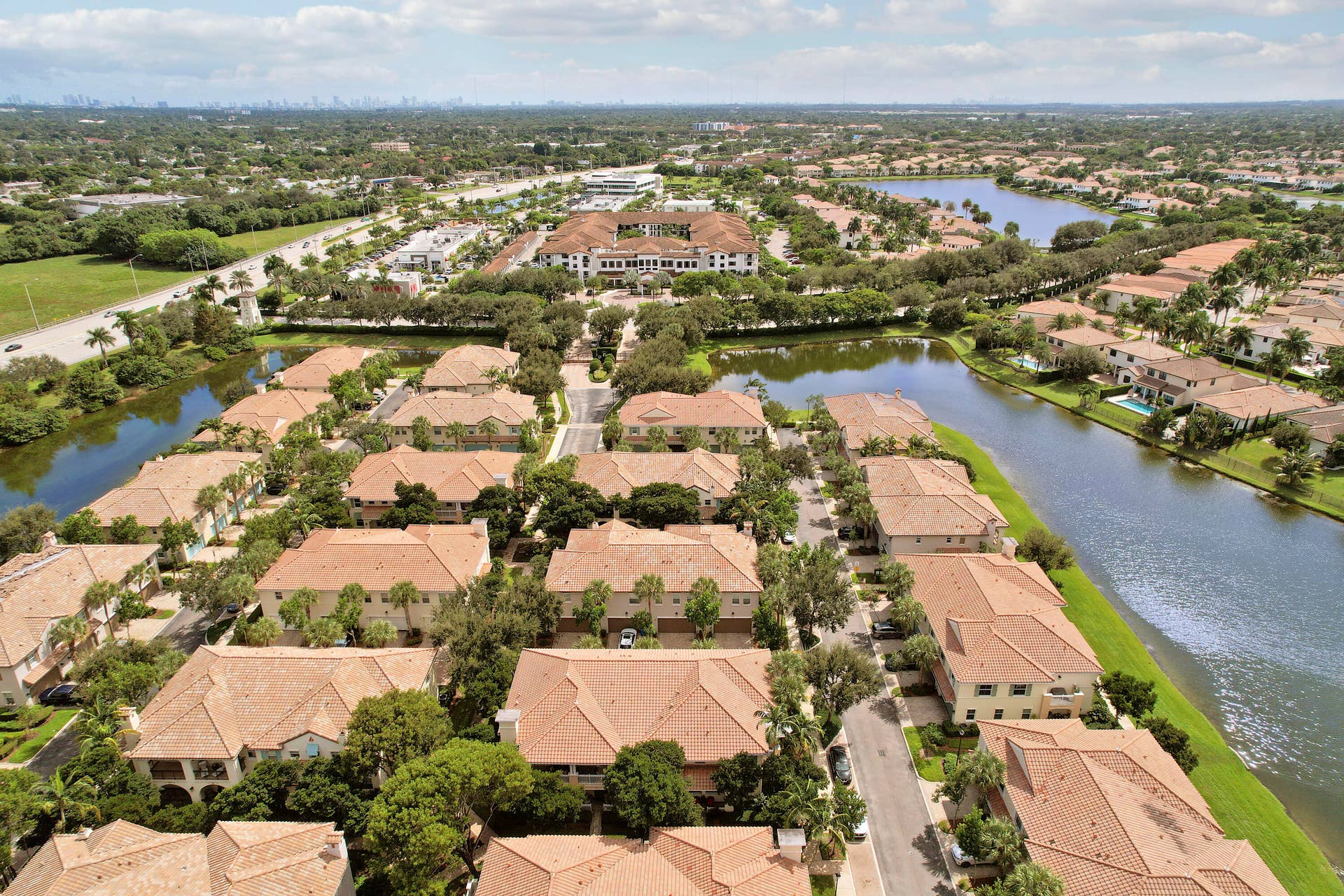 4326 Cascada Circle, Hollywood, FL 33024 Aerial perspective of residential community featuring tile roofs, mature landscaping, and waterfront surroundings