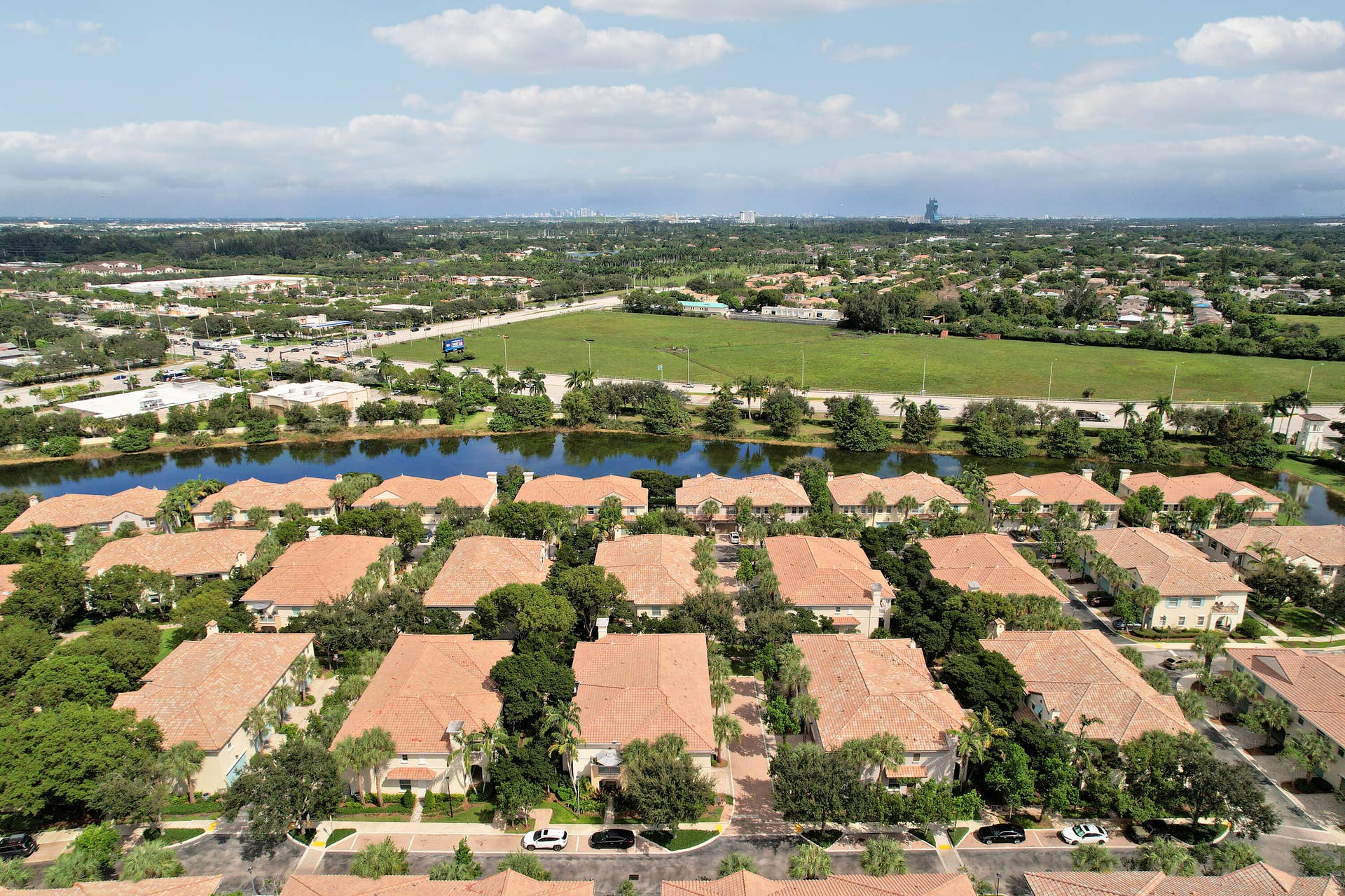 4326 Cascada Circle, Hollywood, FL 33024 Aerial perspective featuring tile roofing, mature landscaping, and proximity to a water feature