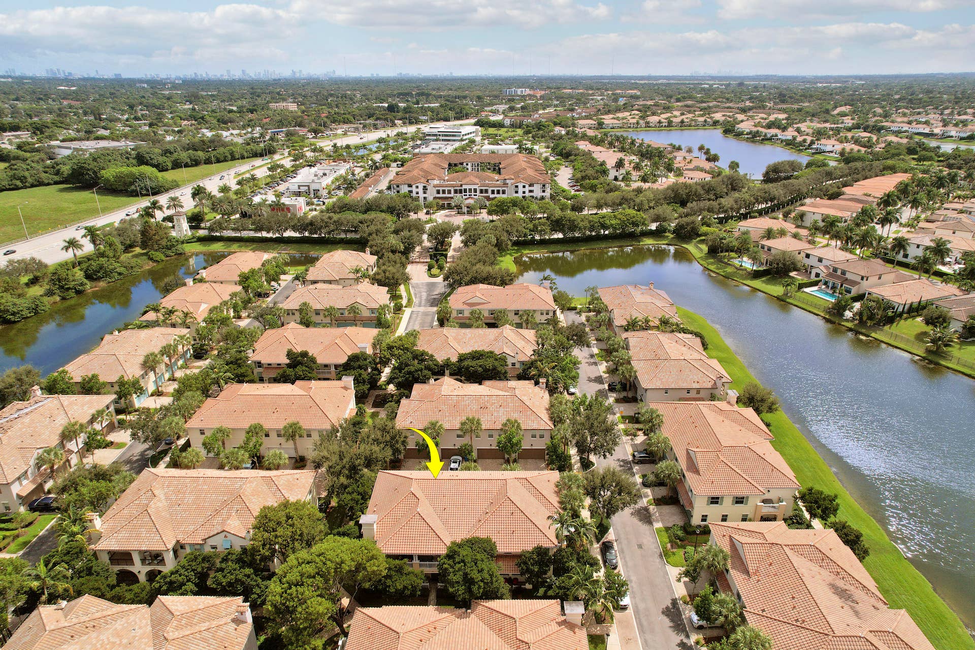 4326 Cascada Circle, Hollywood, FL 33024 Aerial perspective of property featuring a tile roof, mature landscaping, and positioning within a water-front community