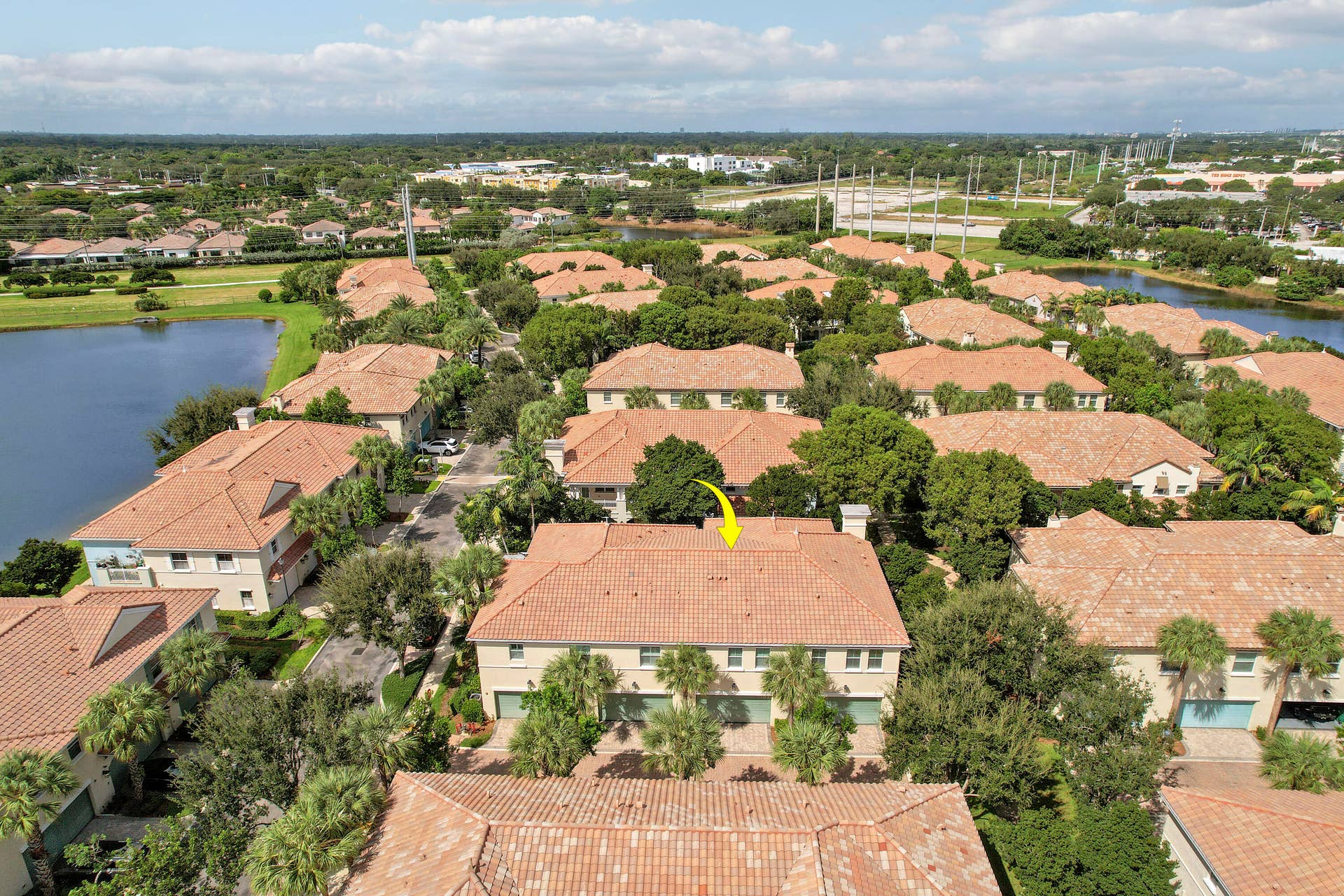 4326 Cascada Circle, Hollywood, FL 33024 Aerial view featuring a multi-story residence with a tile roof, light-toned exterior finish, and multi-car garage configuration