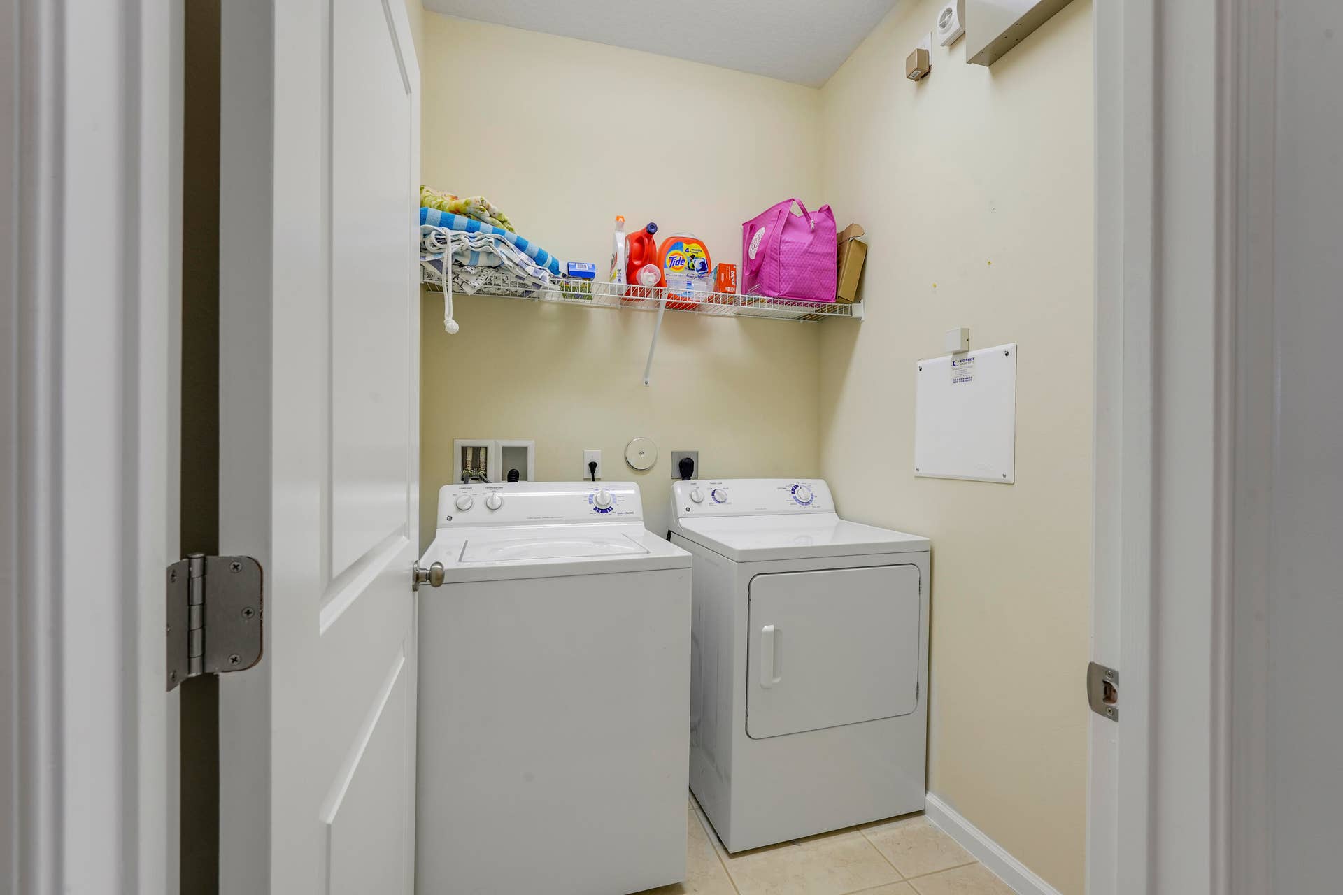 4326 Cascada Circle, Hollywood, FL 33024 Laundry area featuring dedicated washer and dryer hookups, wire shelving, and neutral tile flooring