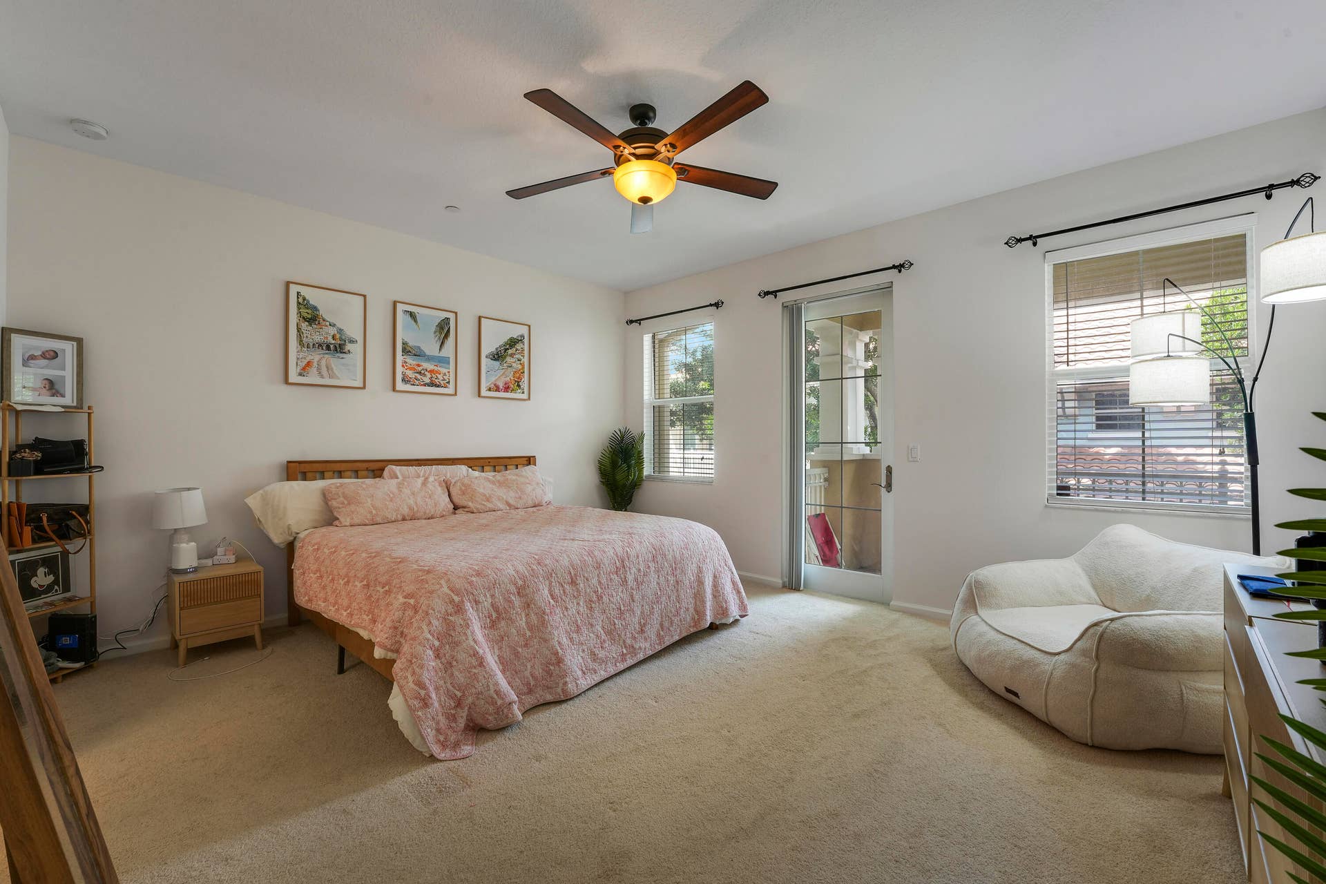 4326 Cascada Circle, Hollywood, FL 33024 Neutral-toned interior featuring wall-to-wall carpeting, a ceiling fan with integrated lighting, multiple windows with horizontal blinds, and a glass-paneled exterior door