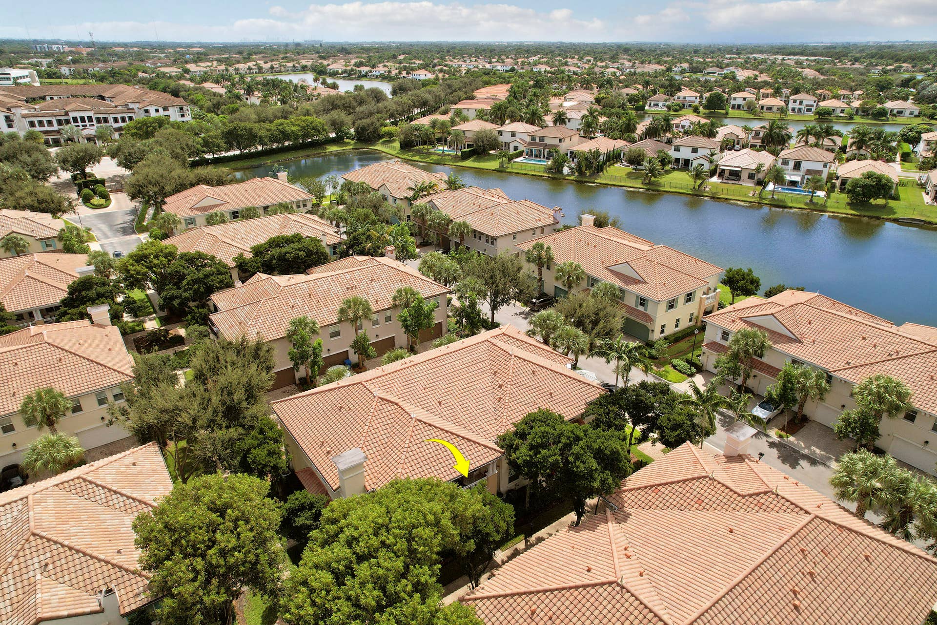 4326 Cascada Circle, Hollywood, FL 33024 Aerial perspective of residential property featuring a tiled roof, exterior chimney, and mature landscaping