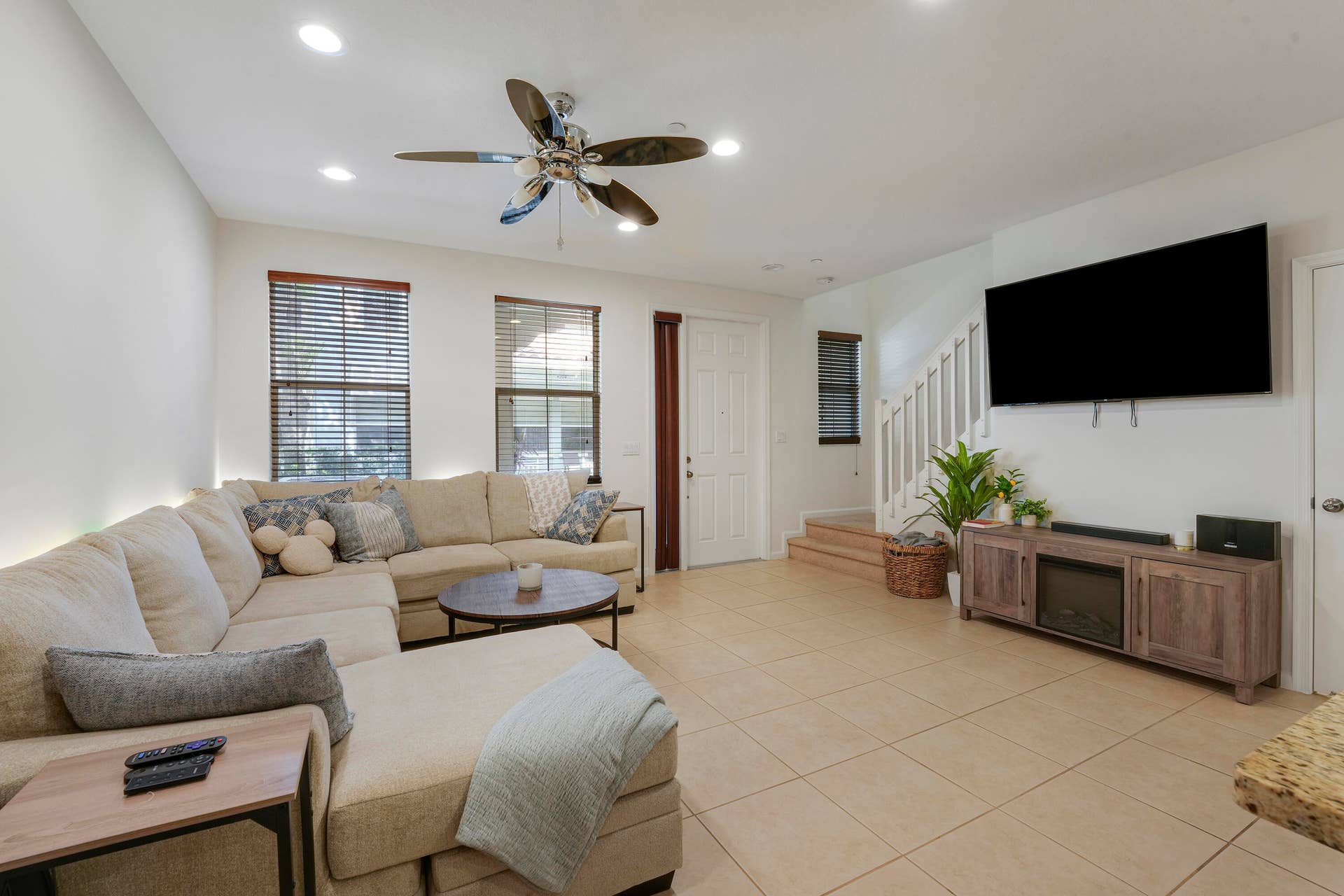 4326 Cascada Circle, Hollywood, FL 33024 Living area featuring neutral tile flooring, recessed ceiling lighting, a multi-blade ceiling fan, and staircase with white vertical balusters