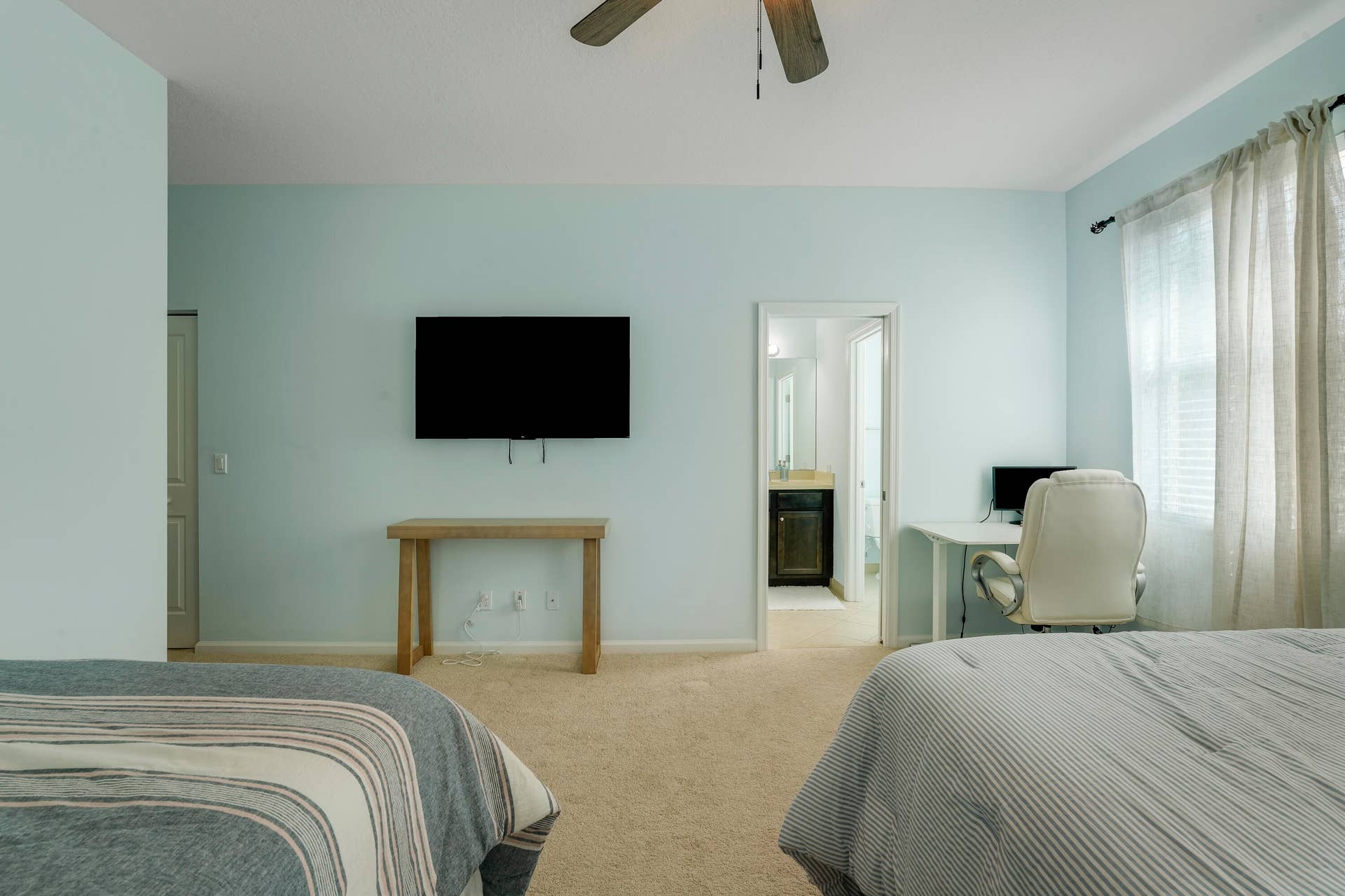 4326 Cascada Circle, Hollywood, FL 33024 Neutral-toned carpeted flooring, ceiling fan with light fixture, and windows with drapery hardware