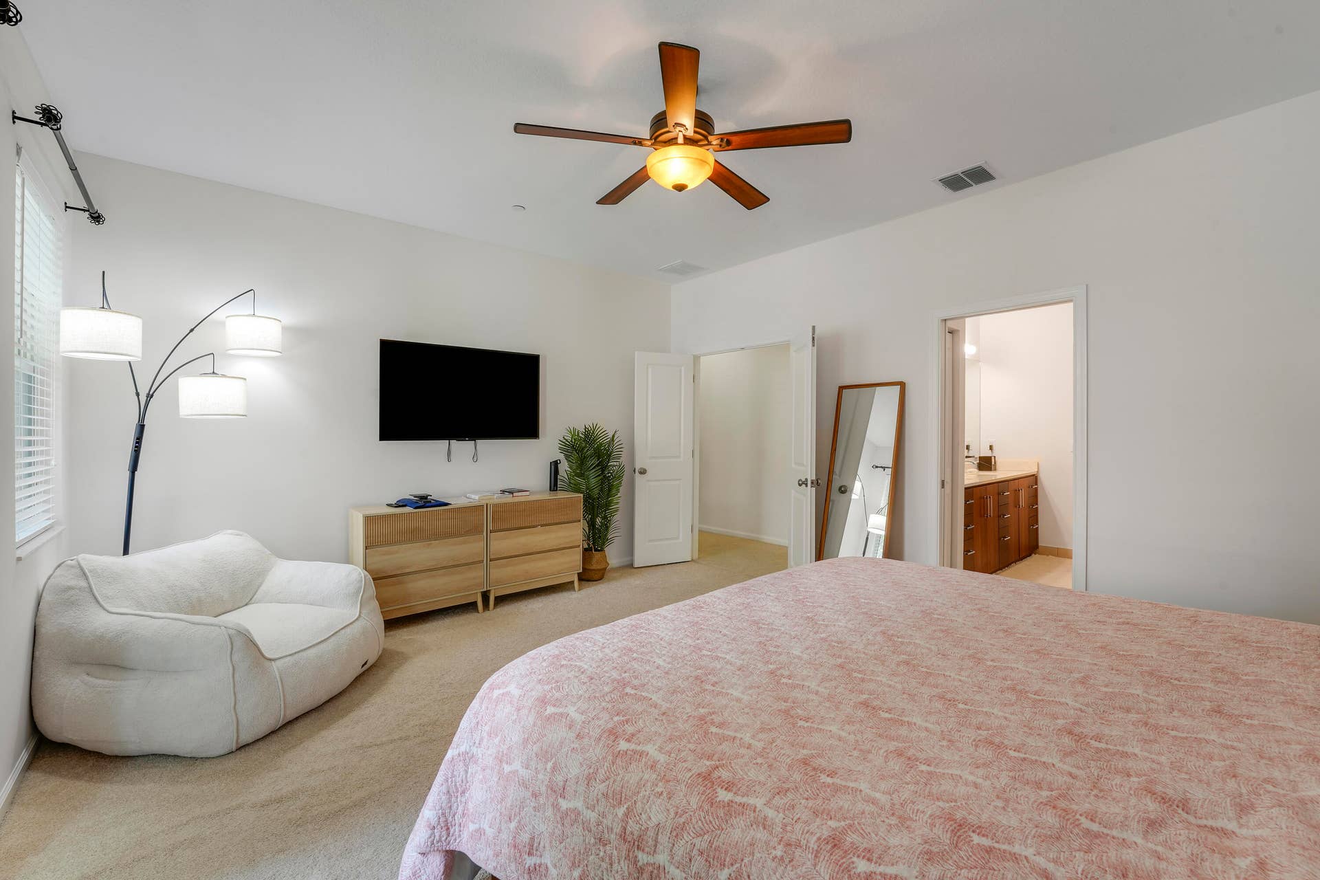 4326 Cascada Circle, Hollywood, FL 33024 Neutral-toned room featuring carpeted flooring, a ceiling fan with integrated lighting, and multiple interior doors